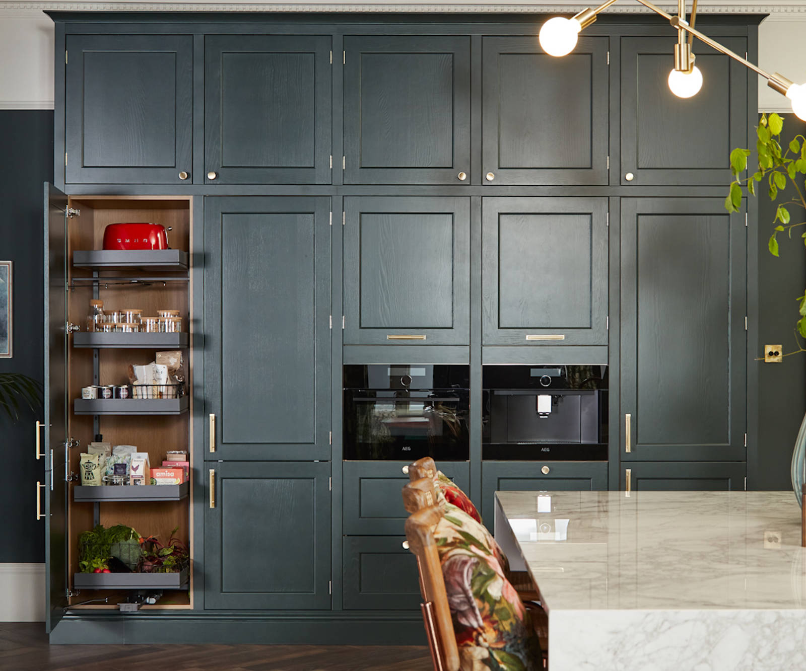 Ludlow, a traditional Shaker-style kitchen range in the shade Arboretum Green, kitchen larder.