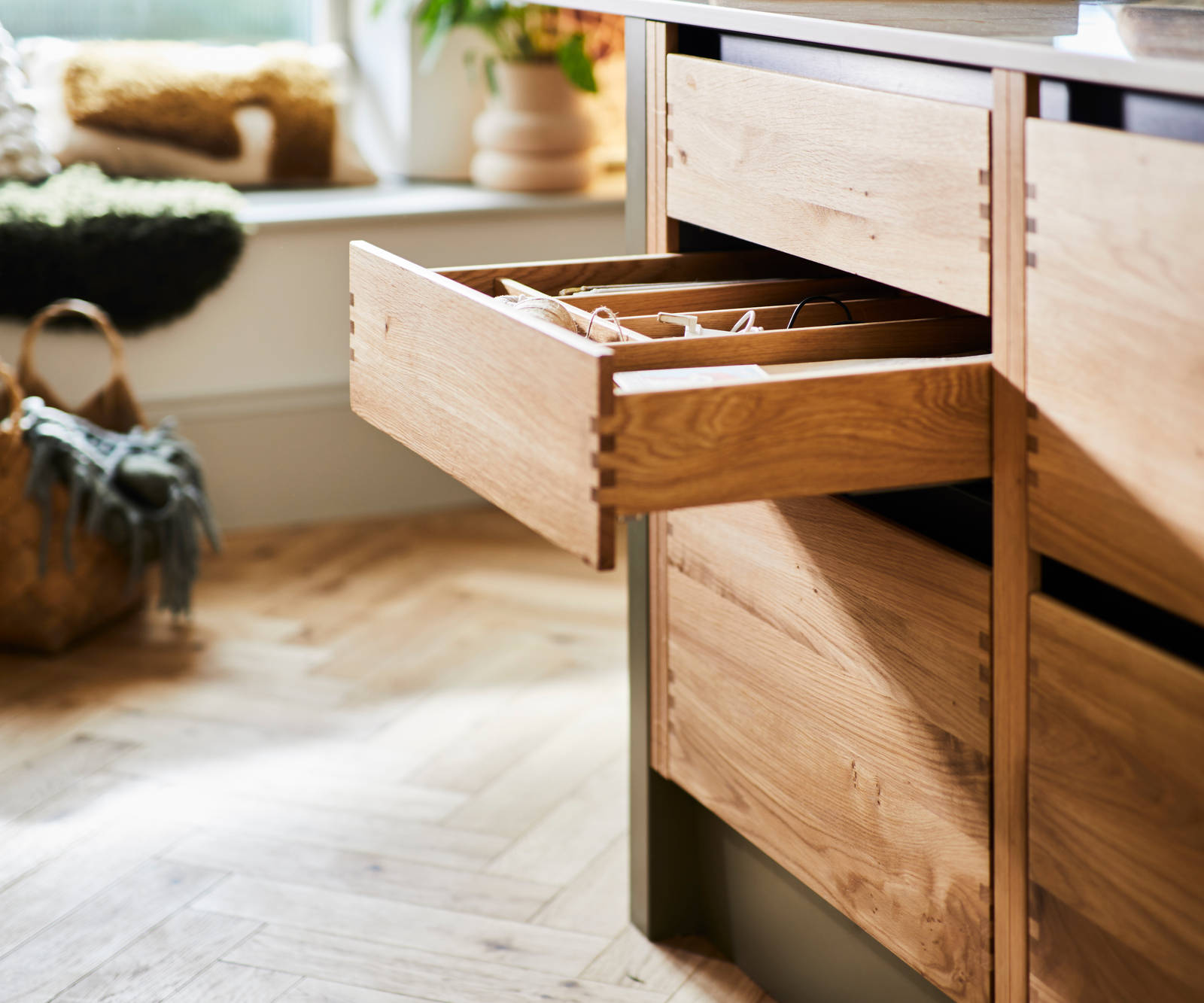 Opened oak drawer with oak inserts in Nordic Craft cabinetry in Magnet customer Jen's kitchen.