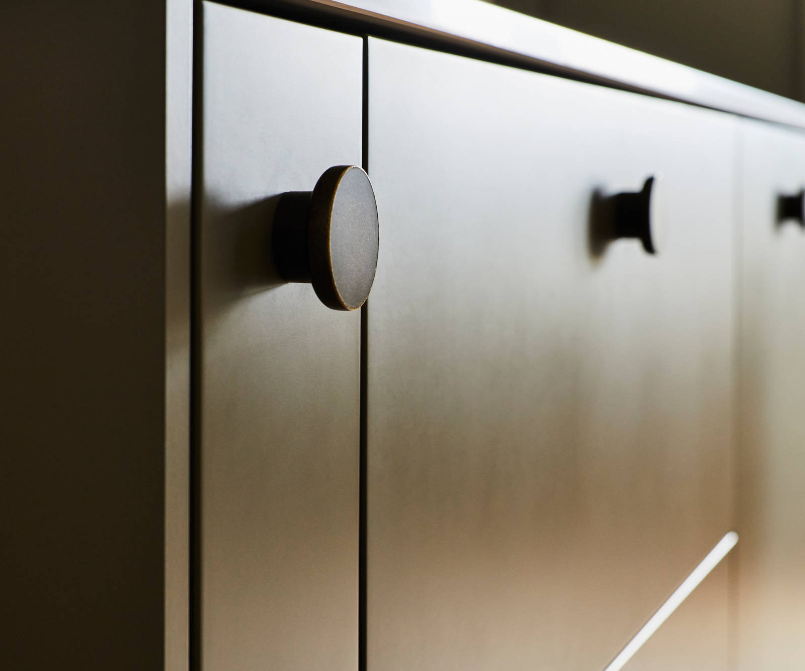 Close-up of Soho Balmoral cabinets with black circle handles