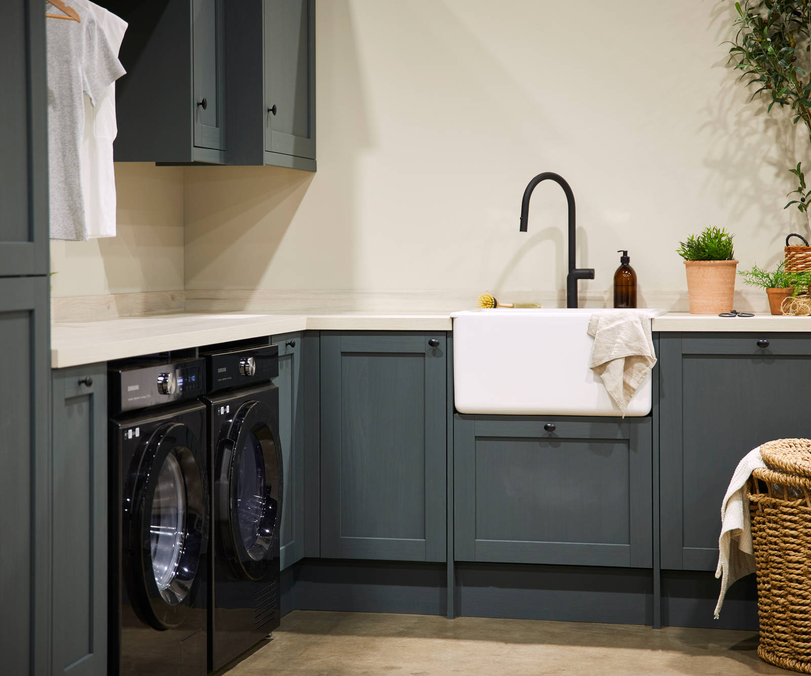 Magnet's Ambleside kitchen, fitted with a butler's sink, matt black tap and black appliances.