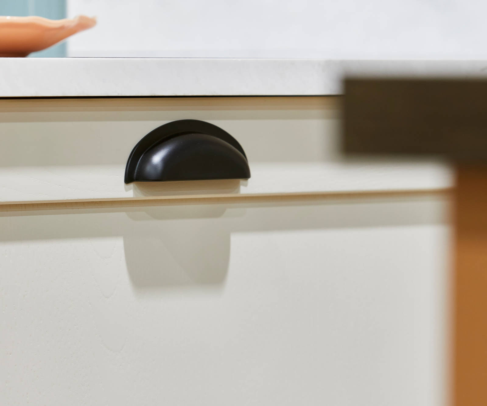 Close-up of black traditional style handle in the shaker kitchen