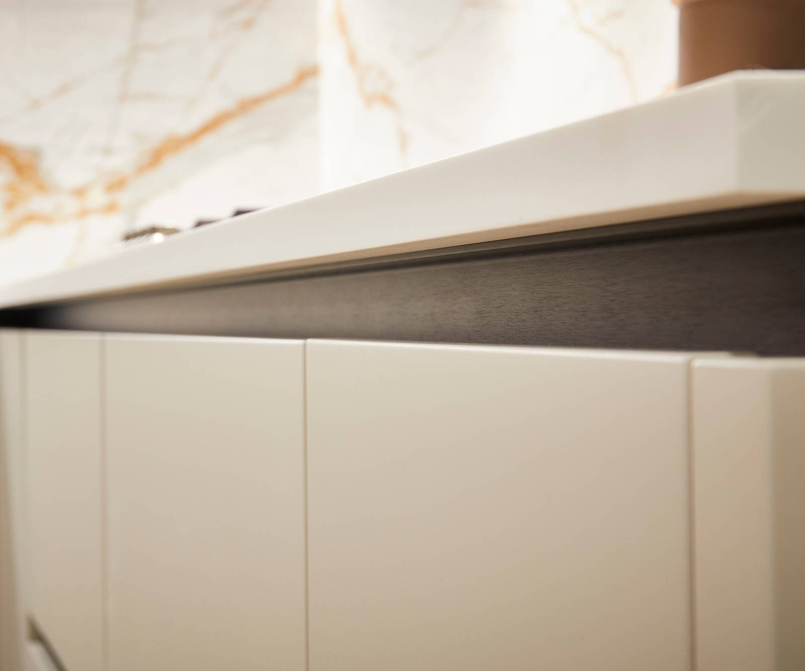 Integra Soho Limestone and Nutmeg is a frameless slab door with integrated handles in a smooth paint finish.