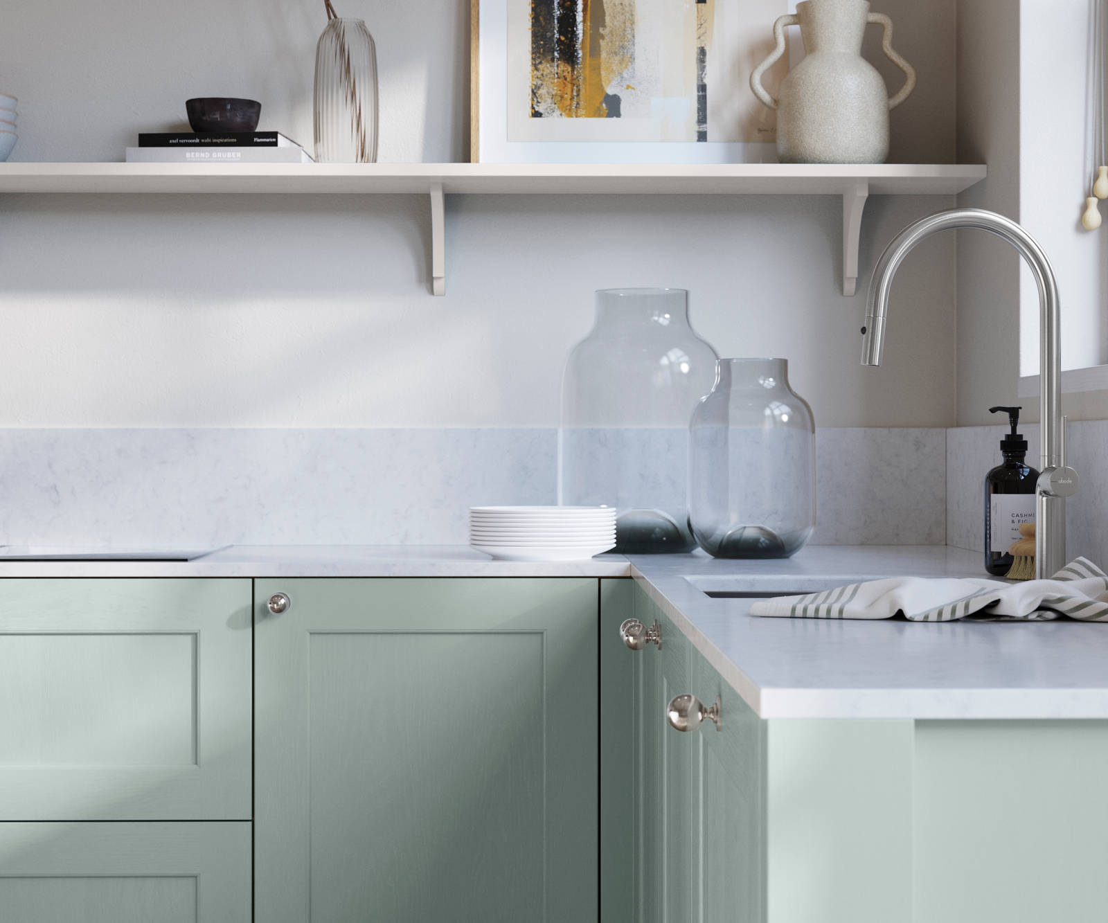 Ludlow, a traditional Shaker-style premium feel kitchen range with a visible woodgrain on its panelled doors here shown in the light blue shade Sky styled with steel knobs, steel tap, a white marbled worktop with matching splashback.