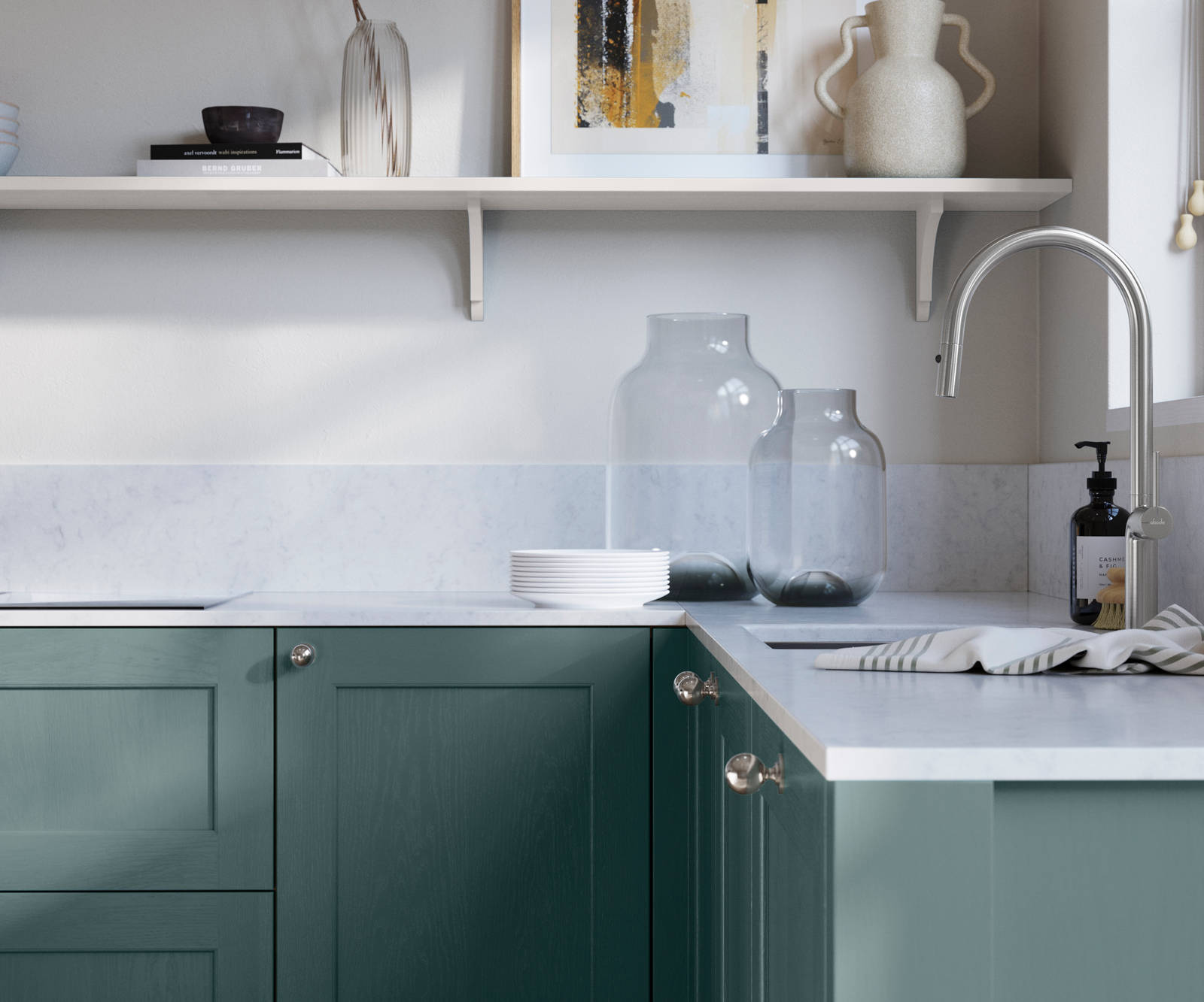Ludlow, a traditional Shaker-style premium feel kitchen range with a visible woodgrain on its panelled doors here shown in the blue shade Morris Blue styled with steel knobs, steel tap, a white marbled worktop with matching splashback.