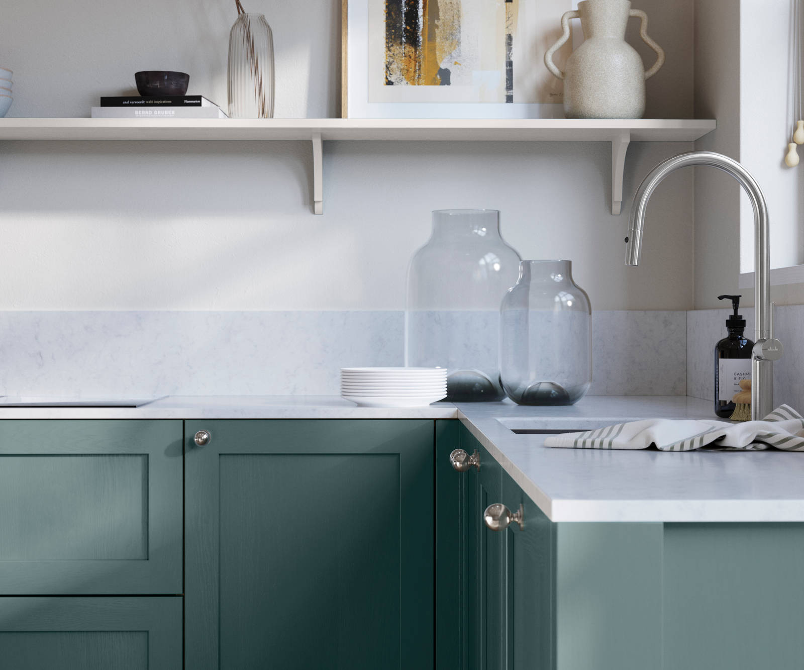 Wardley Morris Blue kitchen cabinetry with steel knobs, steel tap, white marbled worktop and matching backsplash. An open shelf on the wall above cabinets with ceramics and a vase of flowers.