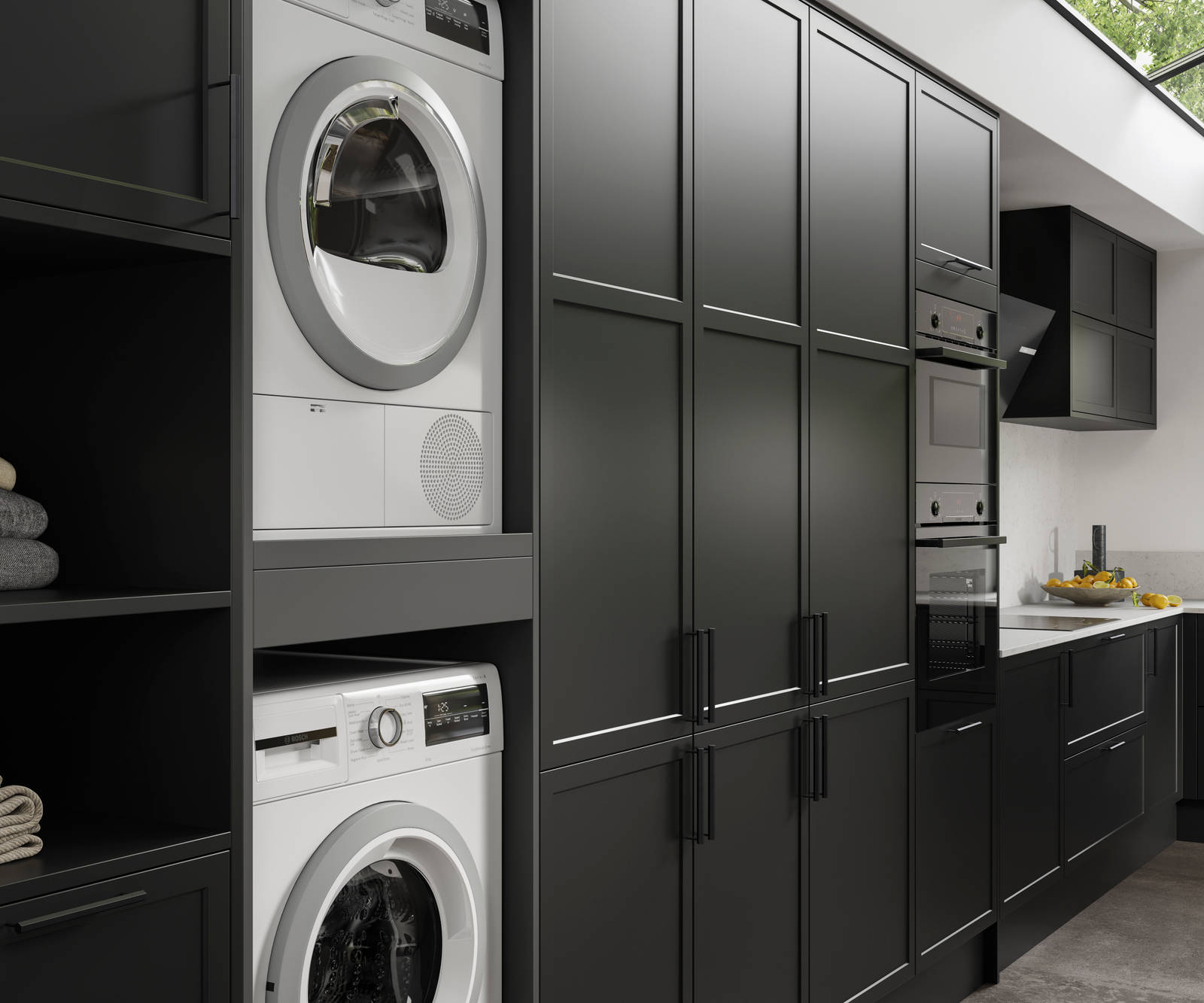 Integrated laundry machine and dryer, tall cabinets in black modern shaker Brunswick kitchen and laundry room.