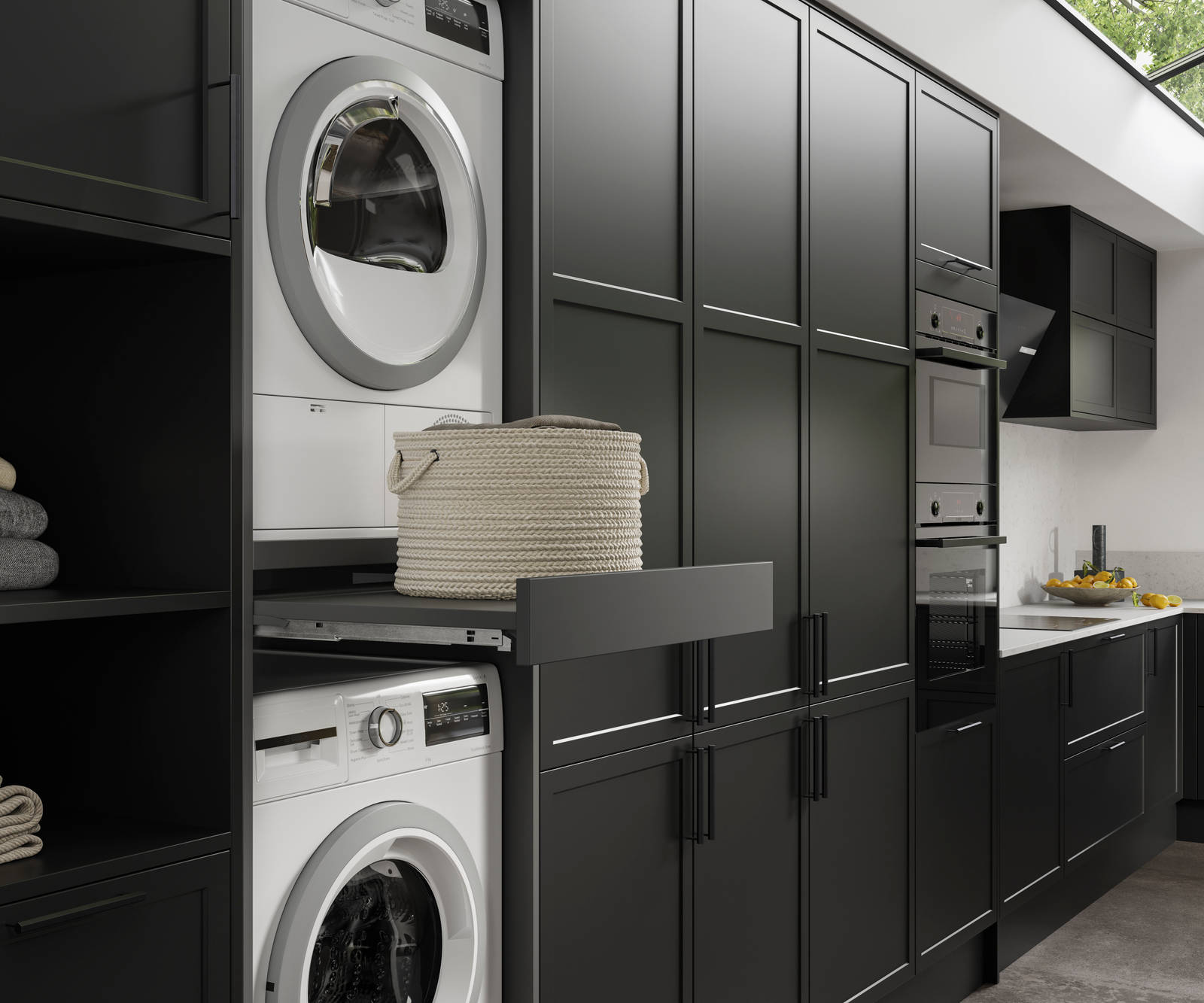 Pulled out drawer between laundry machine and dryer to serve as a shelf in black modern shaker Brunswick kitchen and laundry room