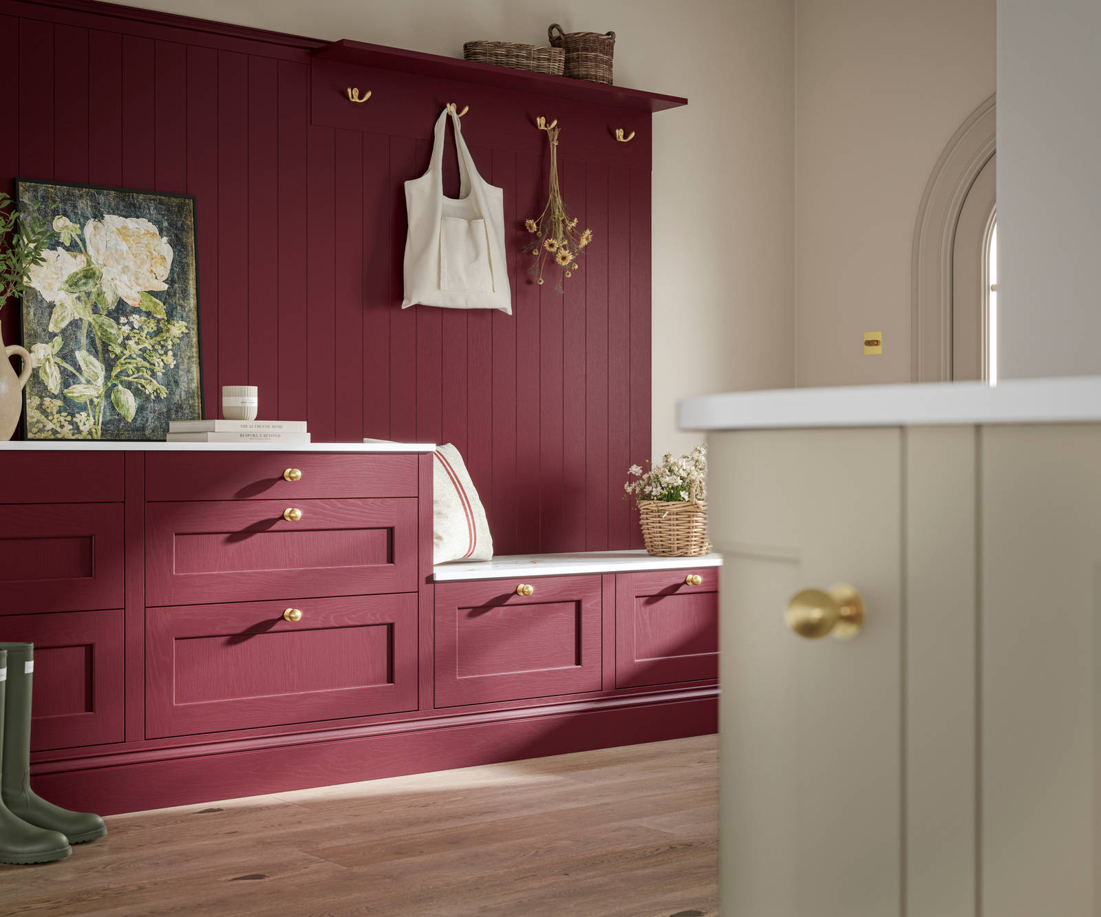Traditional Shaker-style tactile woodgrain Ludlow kitchen bootroom space in bold shade Morello, brass accents and dusty oak vinyl flooring with Ludlow parchment kitchen island in foreground.