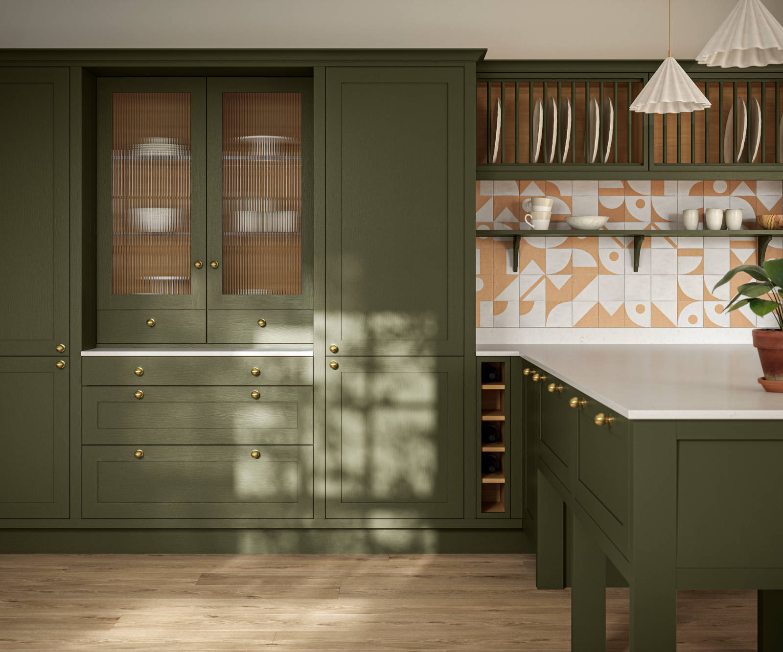 Premium Shaker kitchen Wardley Tailored green with kitchen island, traditional detailing, brass accessories, white worktop and Classic Flint Grey oiled oak engineered wood flooring.