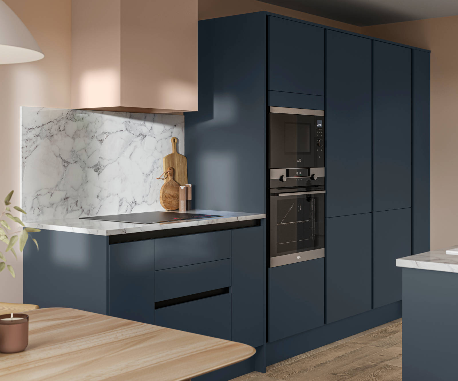 Handleless Integra Ascoli Mineral Blue, a dark blue kitchen with built-in ovens in tall cabinetry, an induction hob in white and grey marbled worktop with matching backsplash.