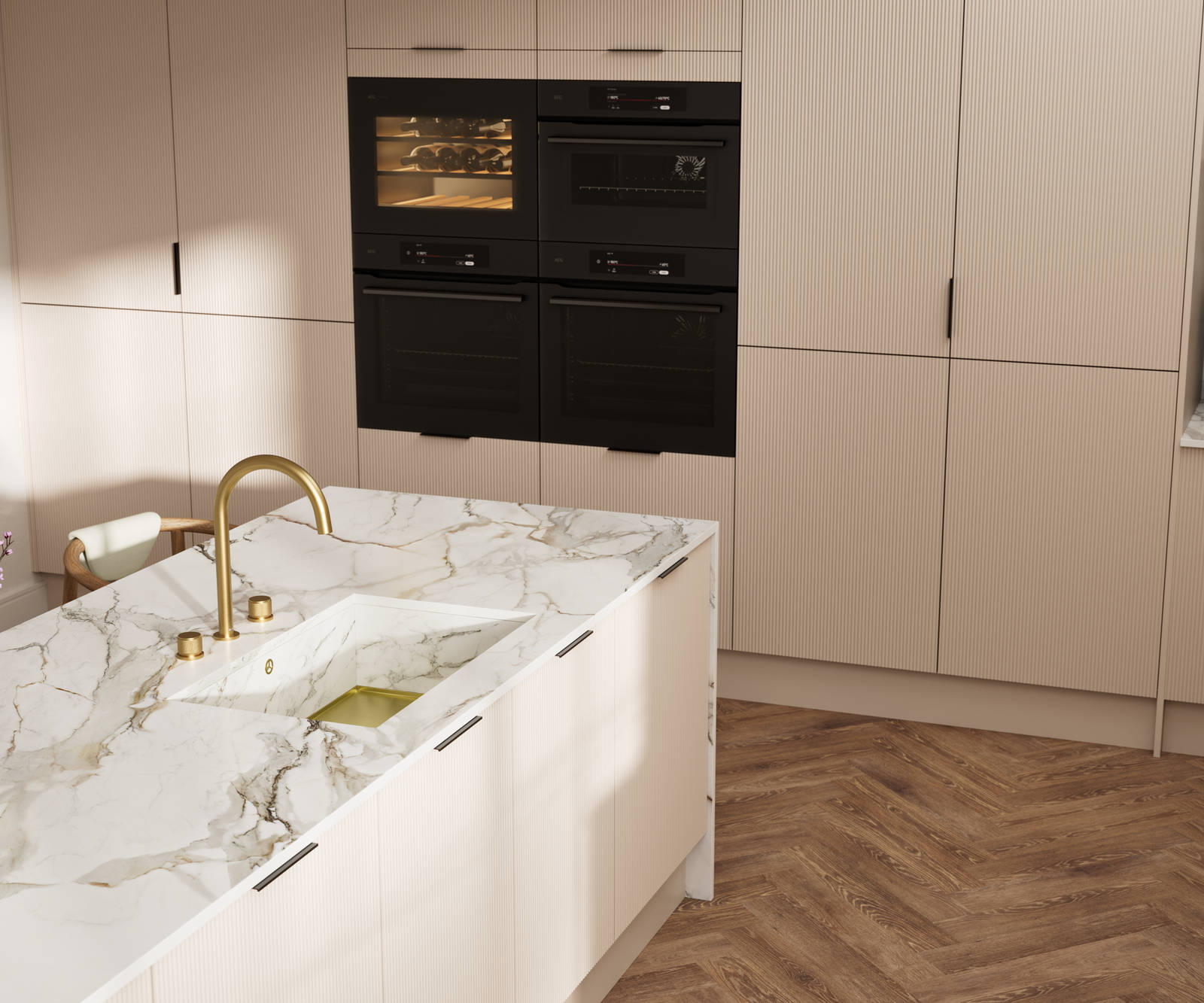 Fluted front kitchen Reed from Magnet in light warm neutral shade Shell, with a marbled splashback and worktop, brass tap in kitchen island sink