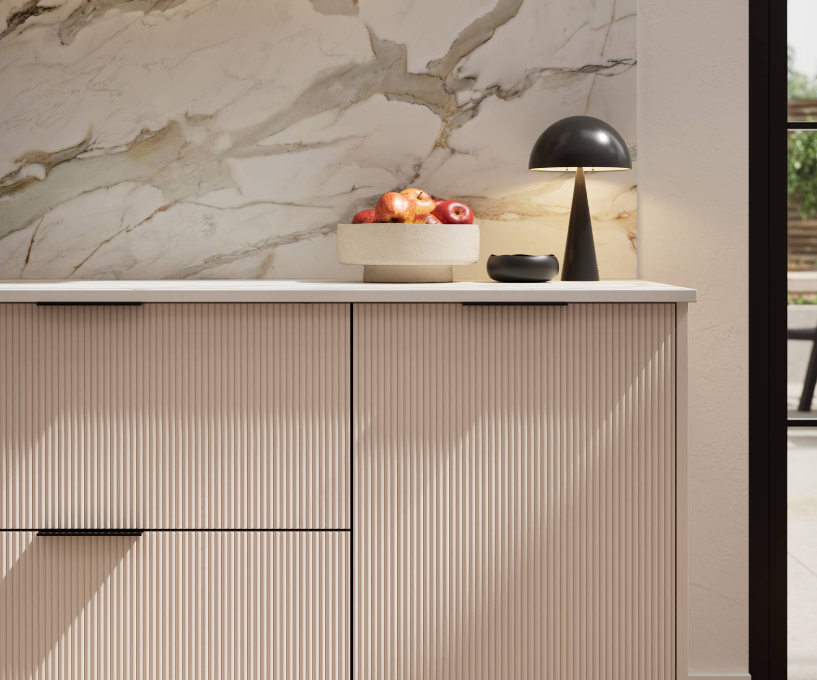 Fluted front kitchen Reed from Magnet in light neutral shade Shell, with a marbled splashback and black handles, herringbone wood flooring.