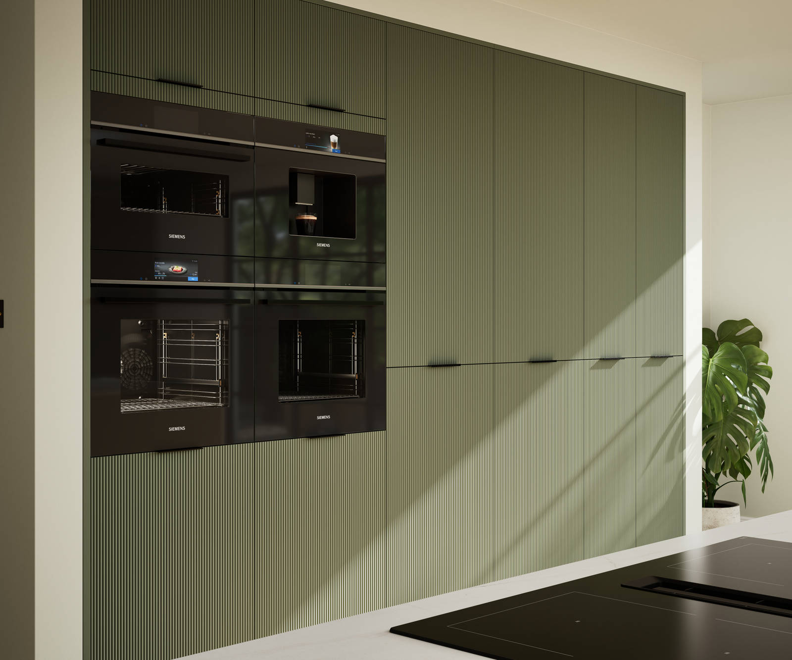 Green fluted kitchen fronts on tall cabinets with built-in appliances and black handles.