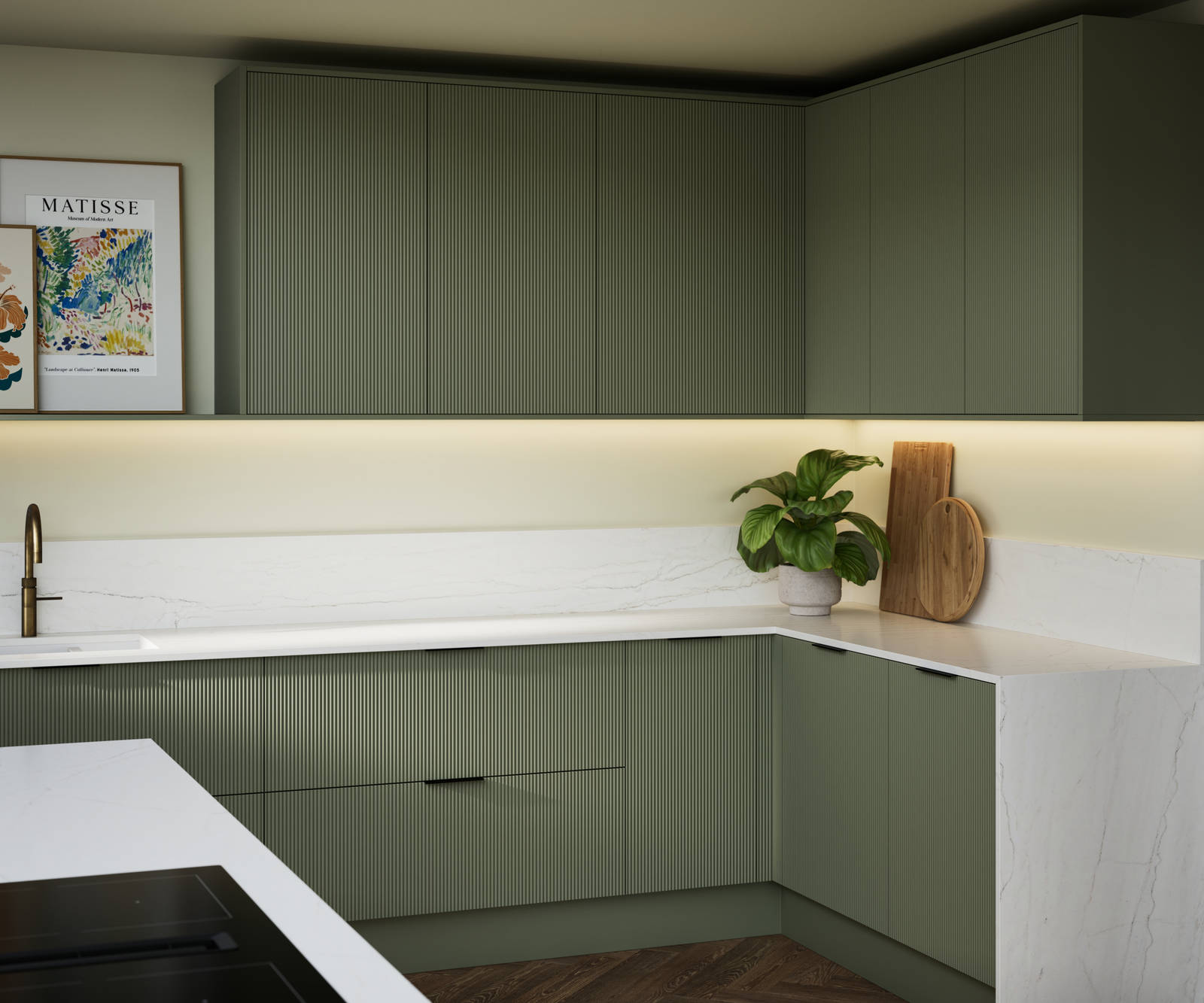 Green fluted kitchen fronts on kitchen cabinets with black handles, white marble worktop, upstand and matching decorative sides.