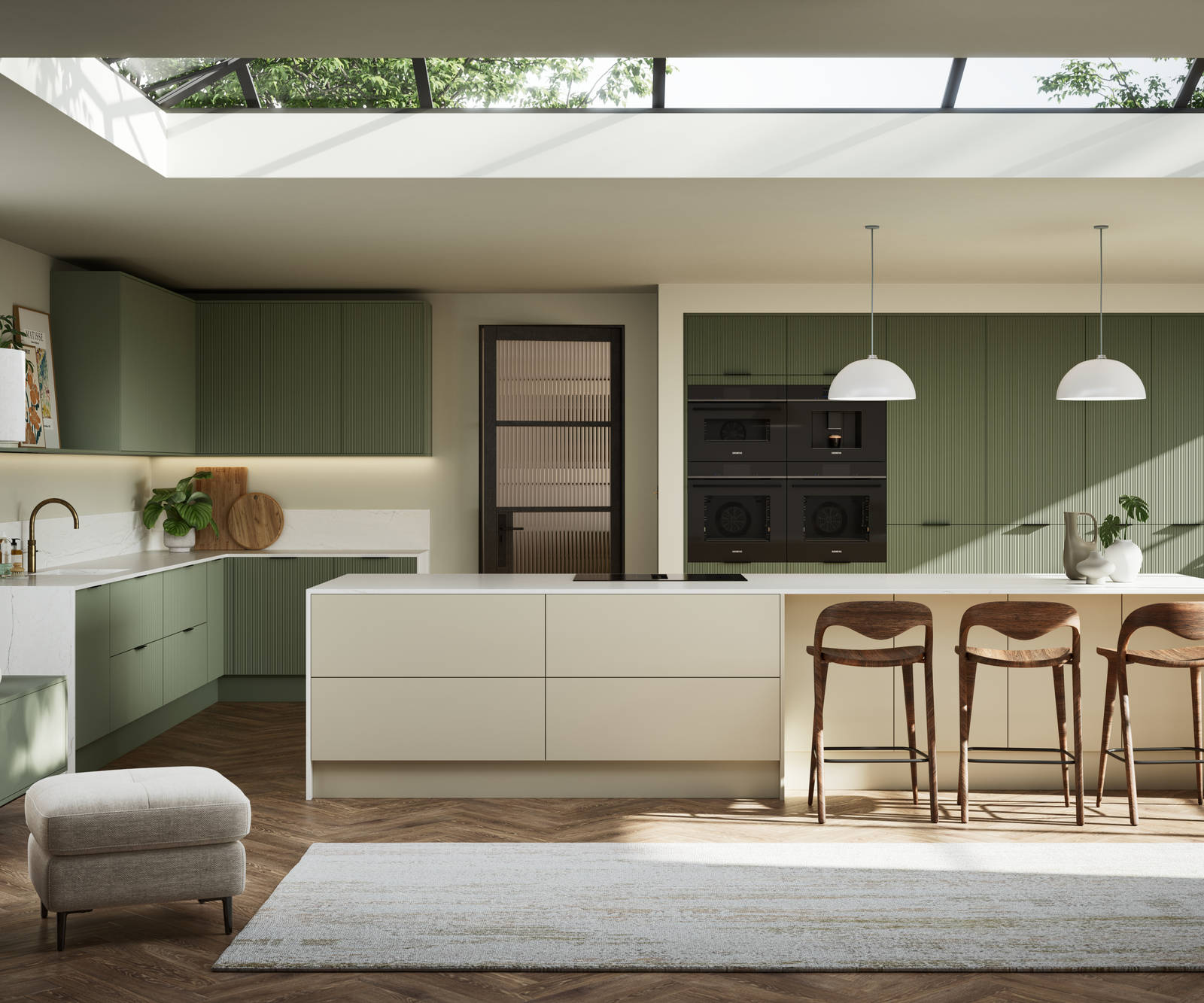 Green fluted kitchen fronts on tall cabinets with built-in appliances and black handles, light neutral shade kitchen island with white worktop and wooden barstools.
