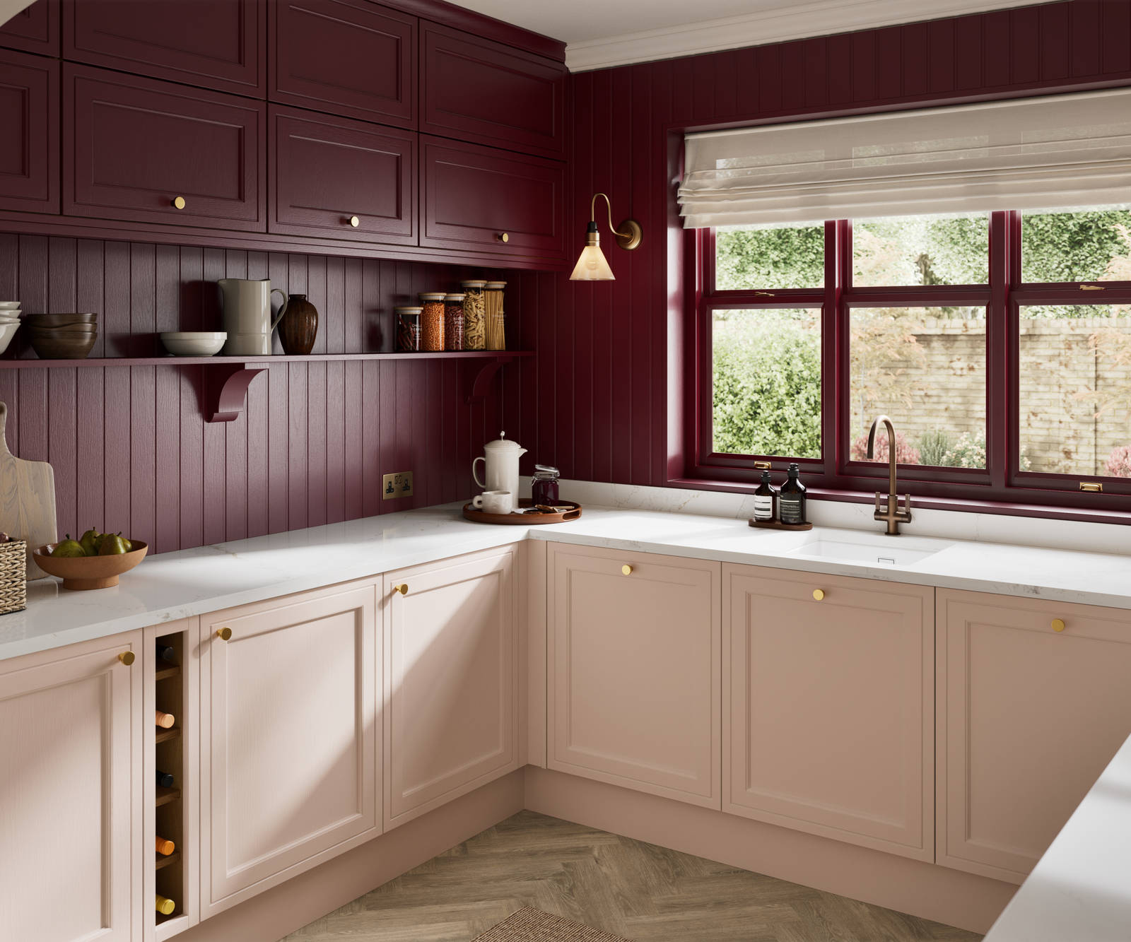 Painted wood grain Shaker style Bewdley kitchen with cabinets in light pink shade Chalk Blush, marbled worktop, brass knobs, red Morello wall-mounted cabinets with matching shelves and wall panel, built- in wine storage.