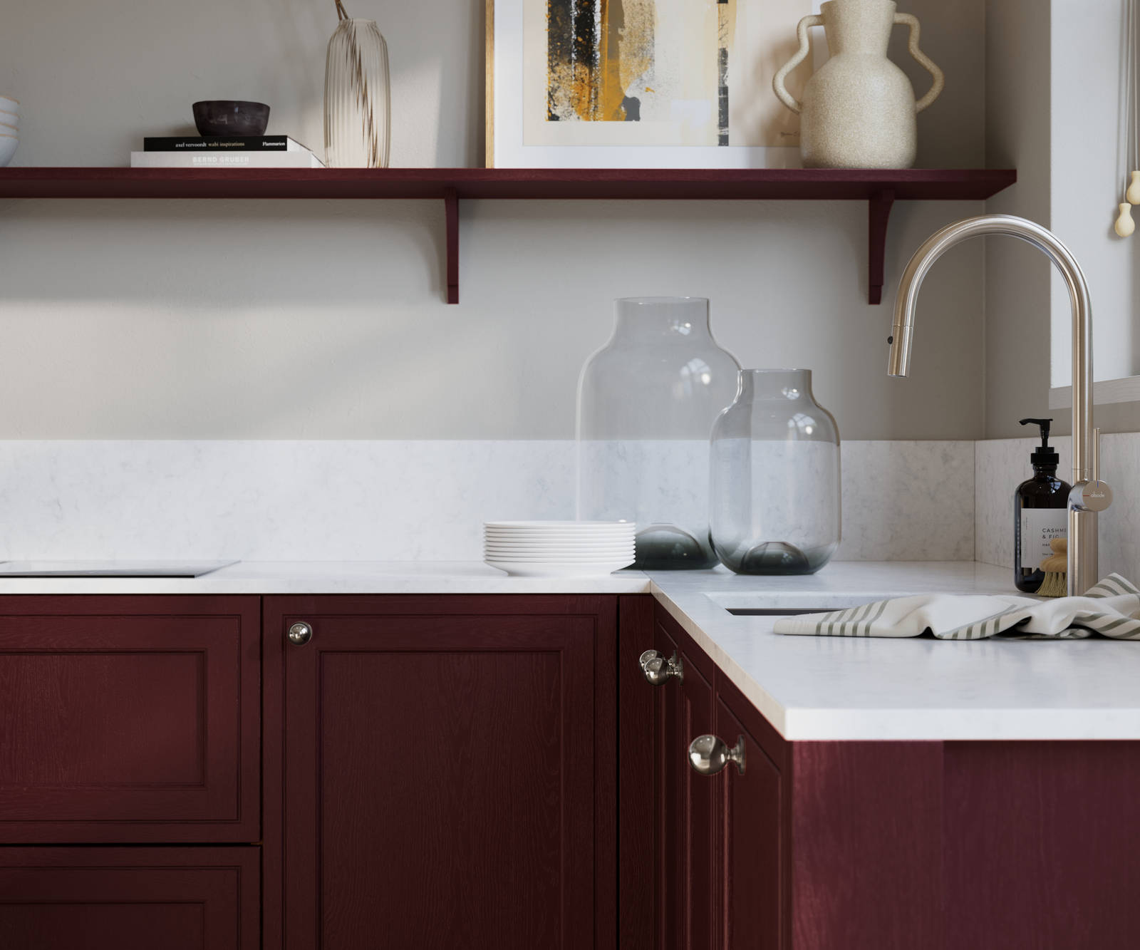 Bewdley Morello painted wood grain Shaker kitchen cabinetry with steel knobs, steel tap, white marbled worktop and matching backsplash, an open shelf on the wall above cabinets with ceramics and a vase of flowers.