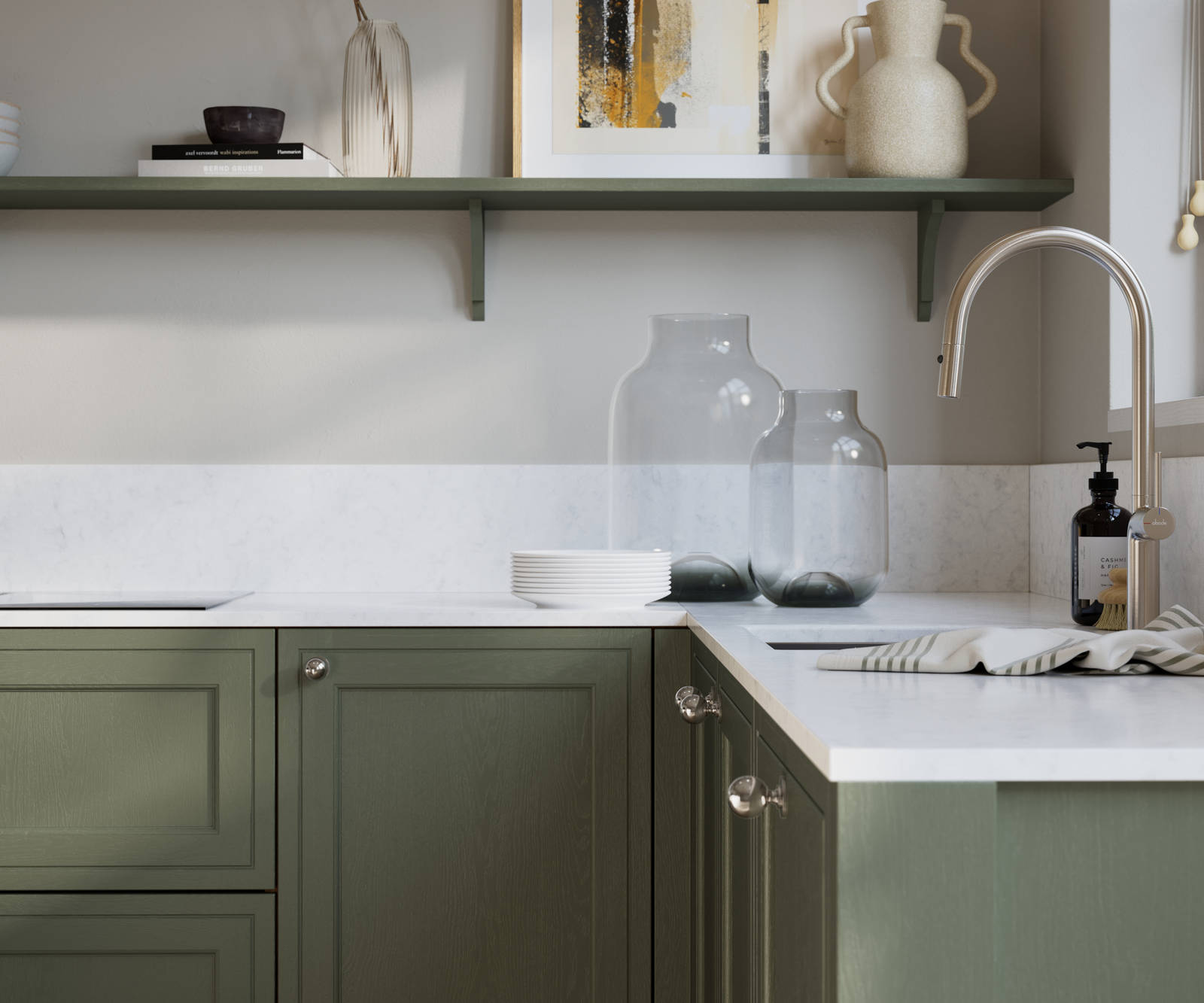 Bewdley Thyme painted wood grain Shaker kitchen cabinetry with steel knobs, steel tap, white marbled worktop and matching backsplash, an open shelf on the wall above cabinets with ceramics and a vase of flowers.