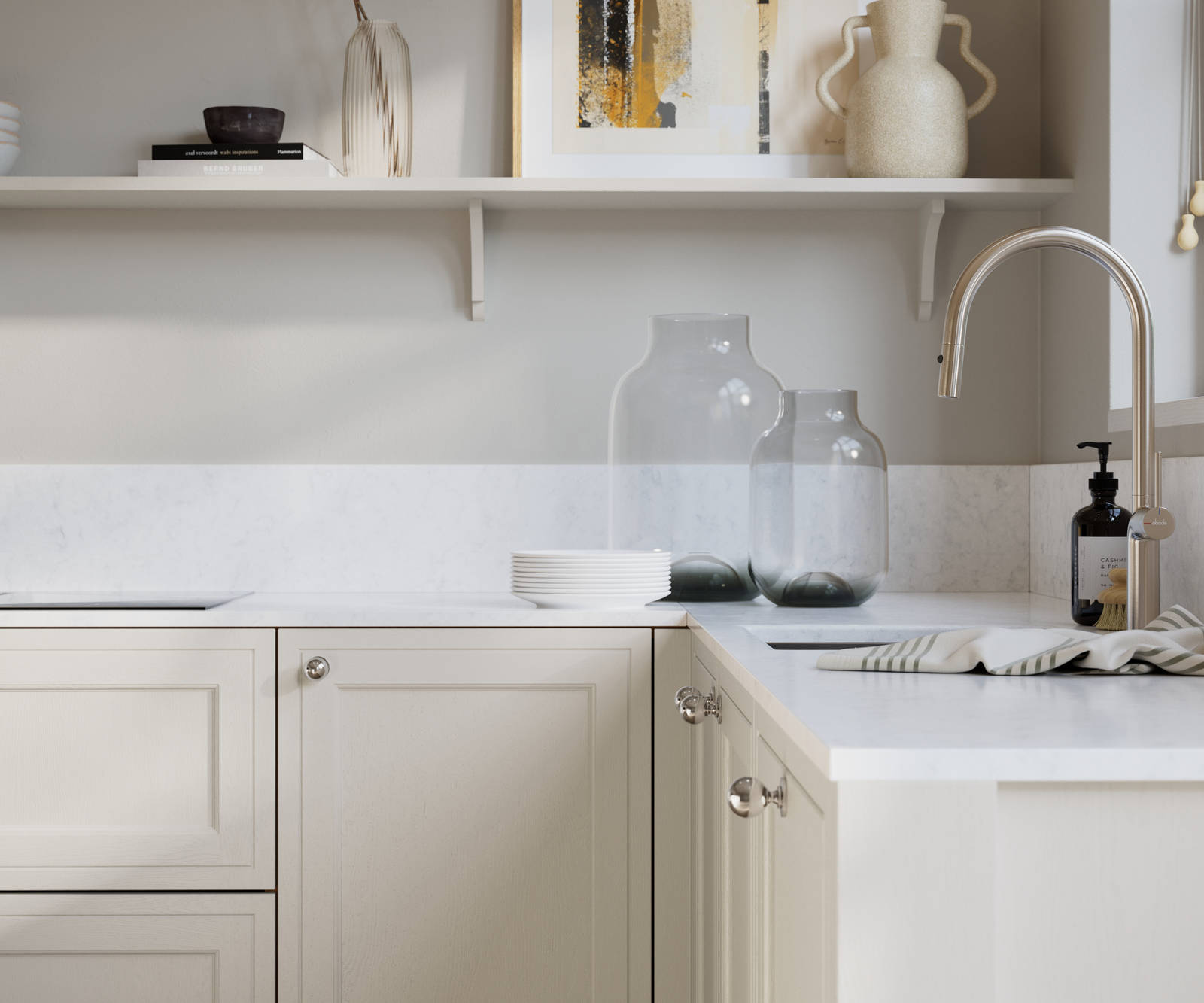 Bewdley Fresh Linen painted wood grain Shaker kitchen cabinetry with steel knobs, steel tap, white marbled worktop and matching backsplash, an open shelf on the wall above cabinets with ceramics and a vase of flowers.