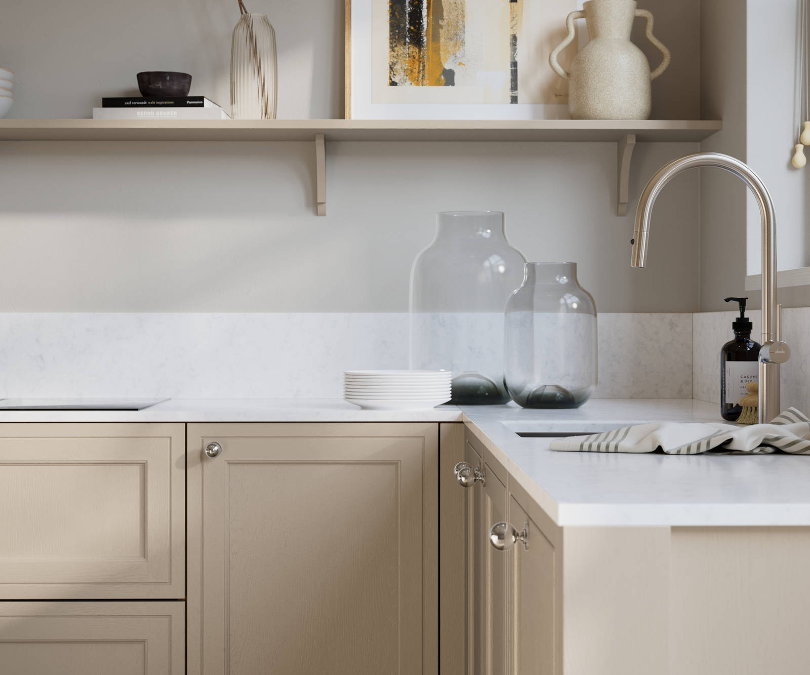 Bewdley Pebble Path painted wood grain Shaker kitchen cabinetry with steel knobs, steel tap, white marbled worktop and matching backsplash, an open shelf on the wall above cabinets with ceramics and a vase of flowers.