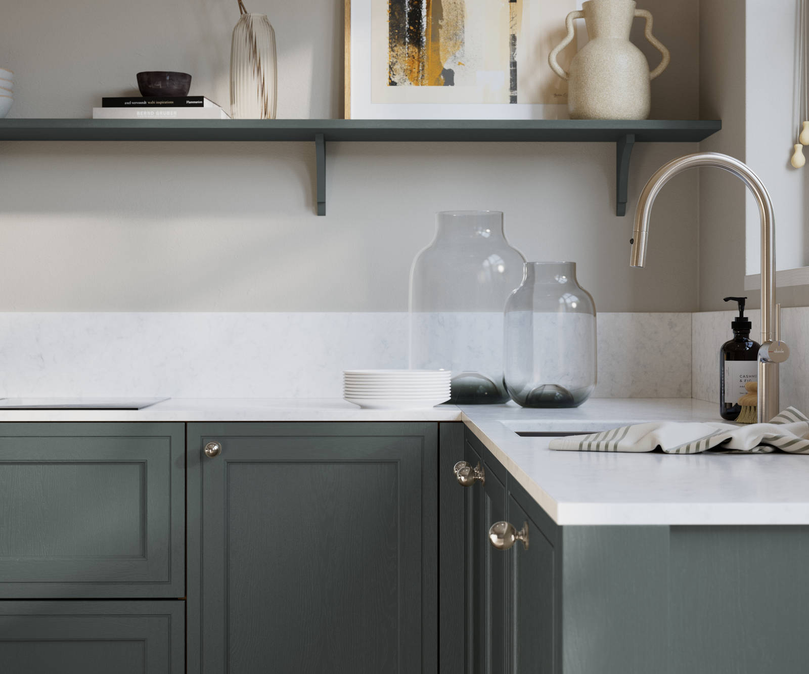 Bewdley Arboretum Green painted wood grain Shaker kitchen cabinetry with steel knobs, steel tap, white marbled worktop and matching backsplash, an open shelf on the wall above cabinets with ceramics and a vase of flowers.