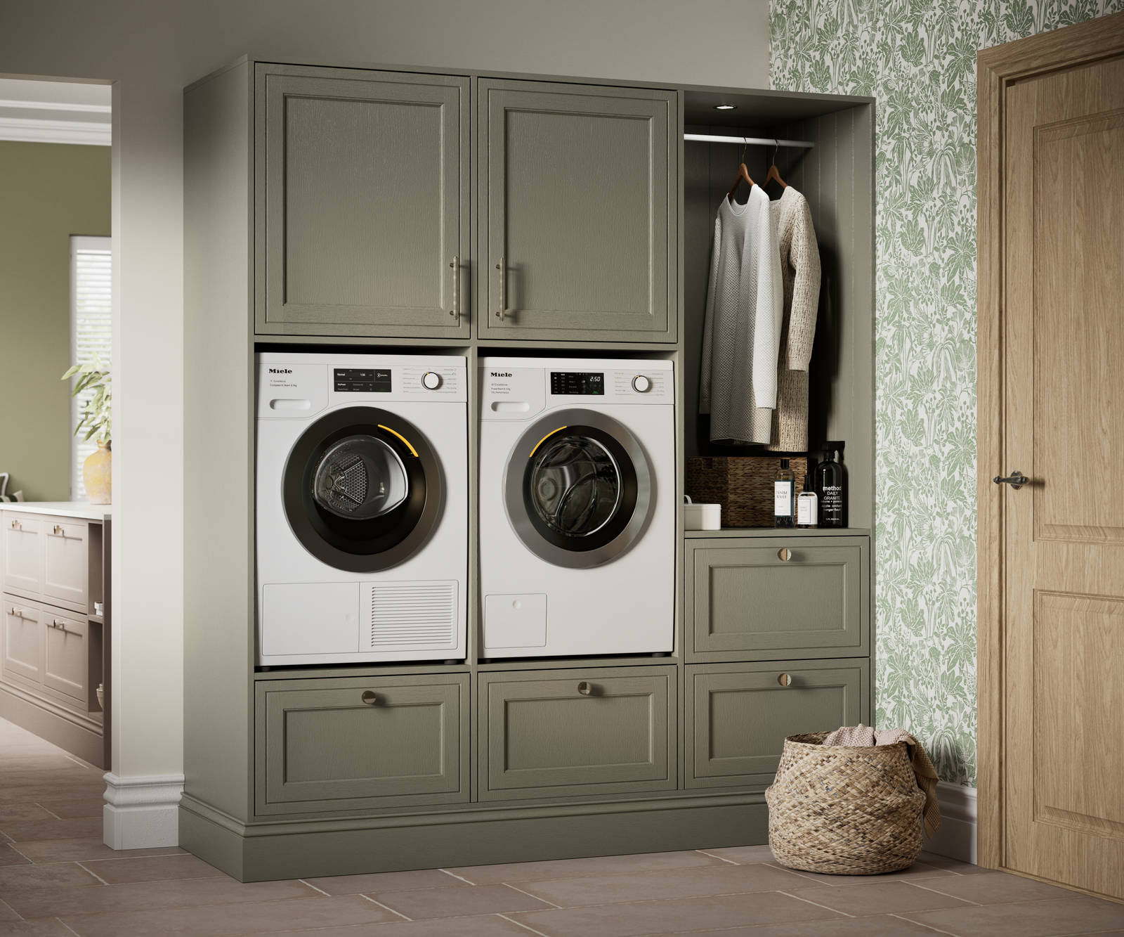Shaker style painted wood grain cabinets Bewdley cabinetry laundry room, tall cabinets with built-in washing machine and tumble dryer in green shade Balmoral.