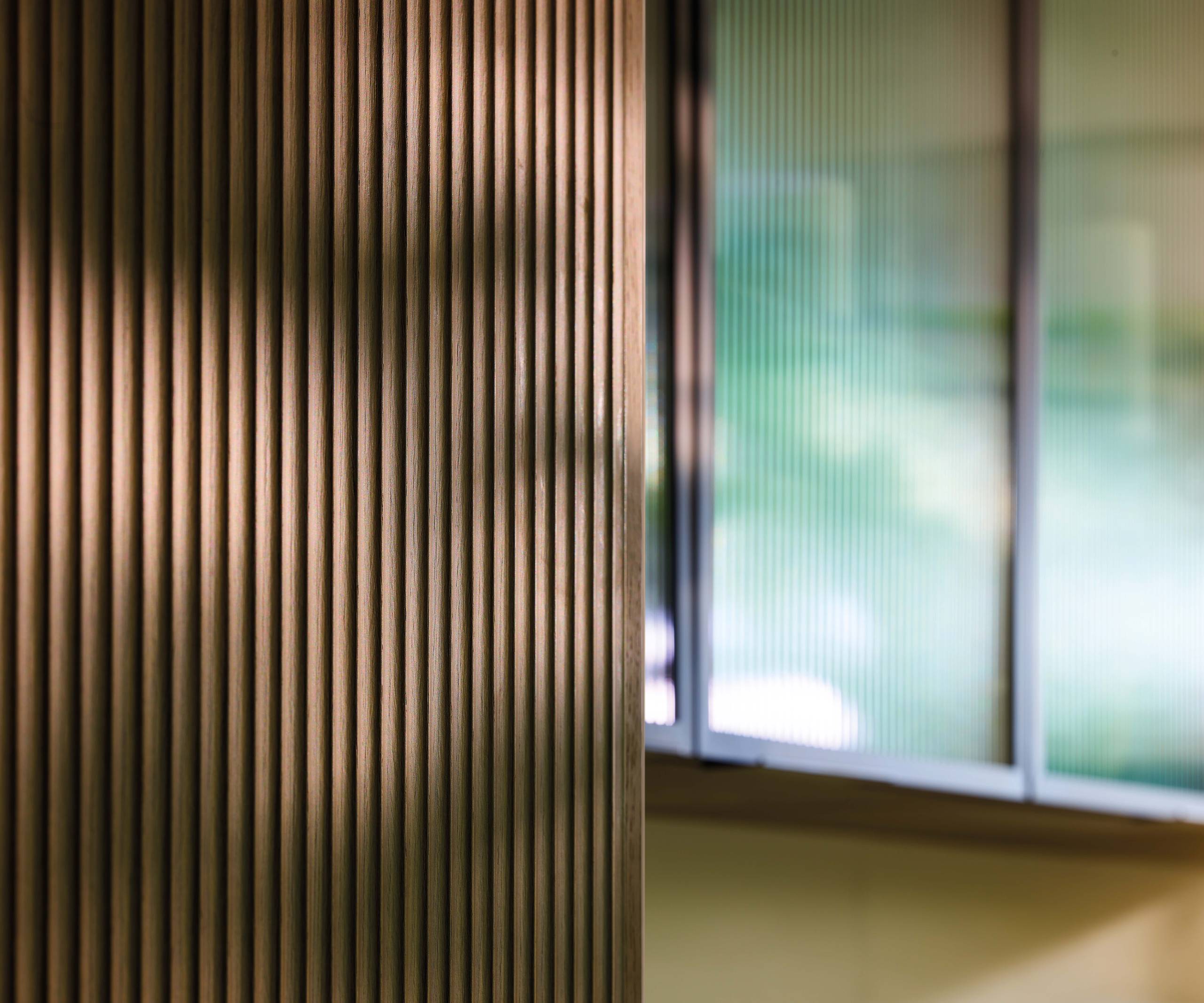 View of fluted wood front with display cabinetry in the background.