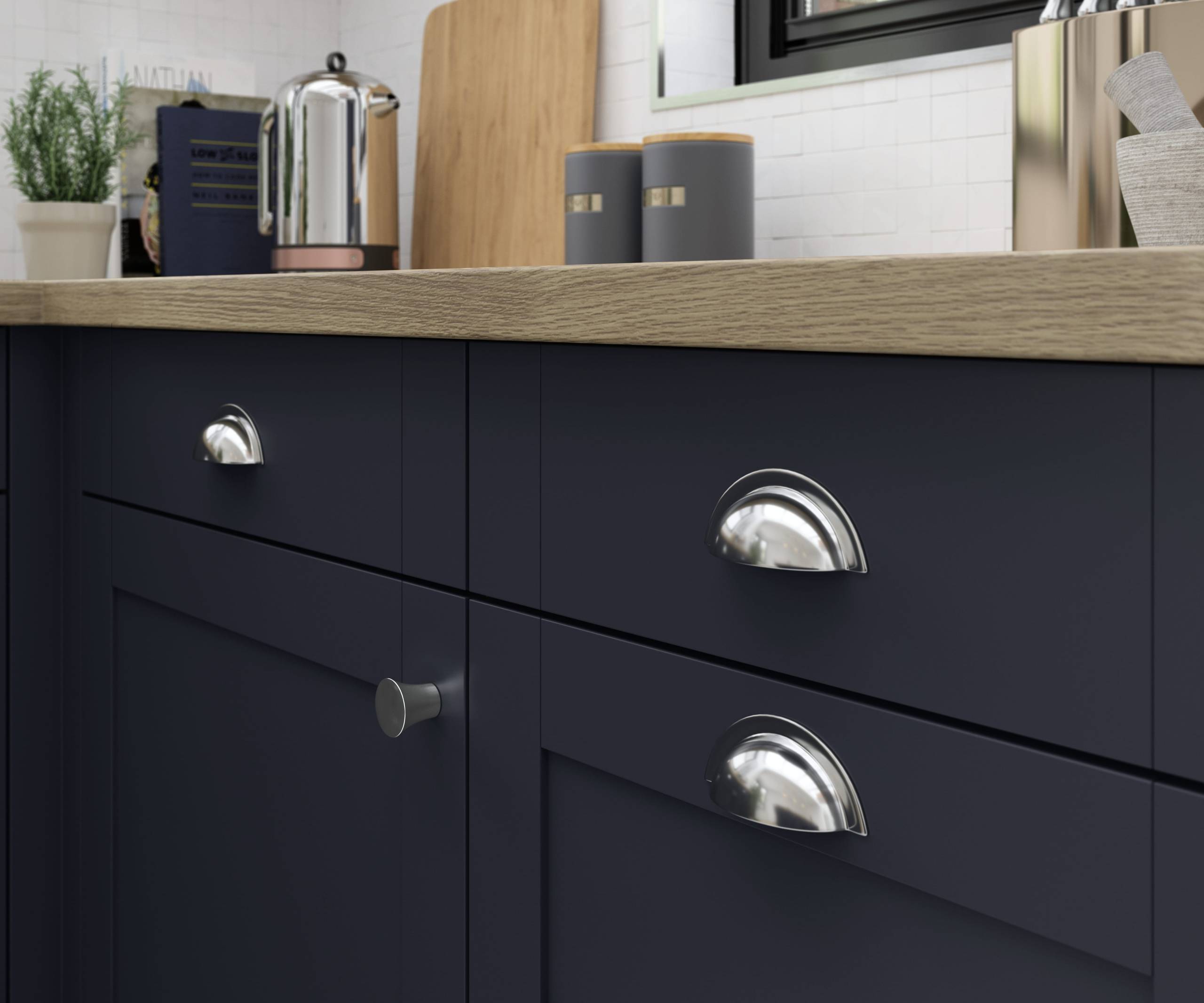 Close-up of Tatton Midnight kitchen from Magnet, a contemporary dark blue narrow frame shaker door, with steel handles and wood worktop.