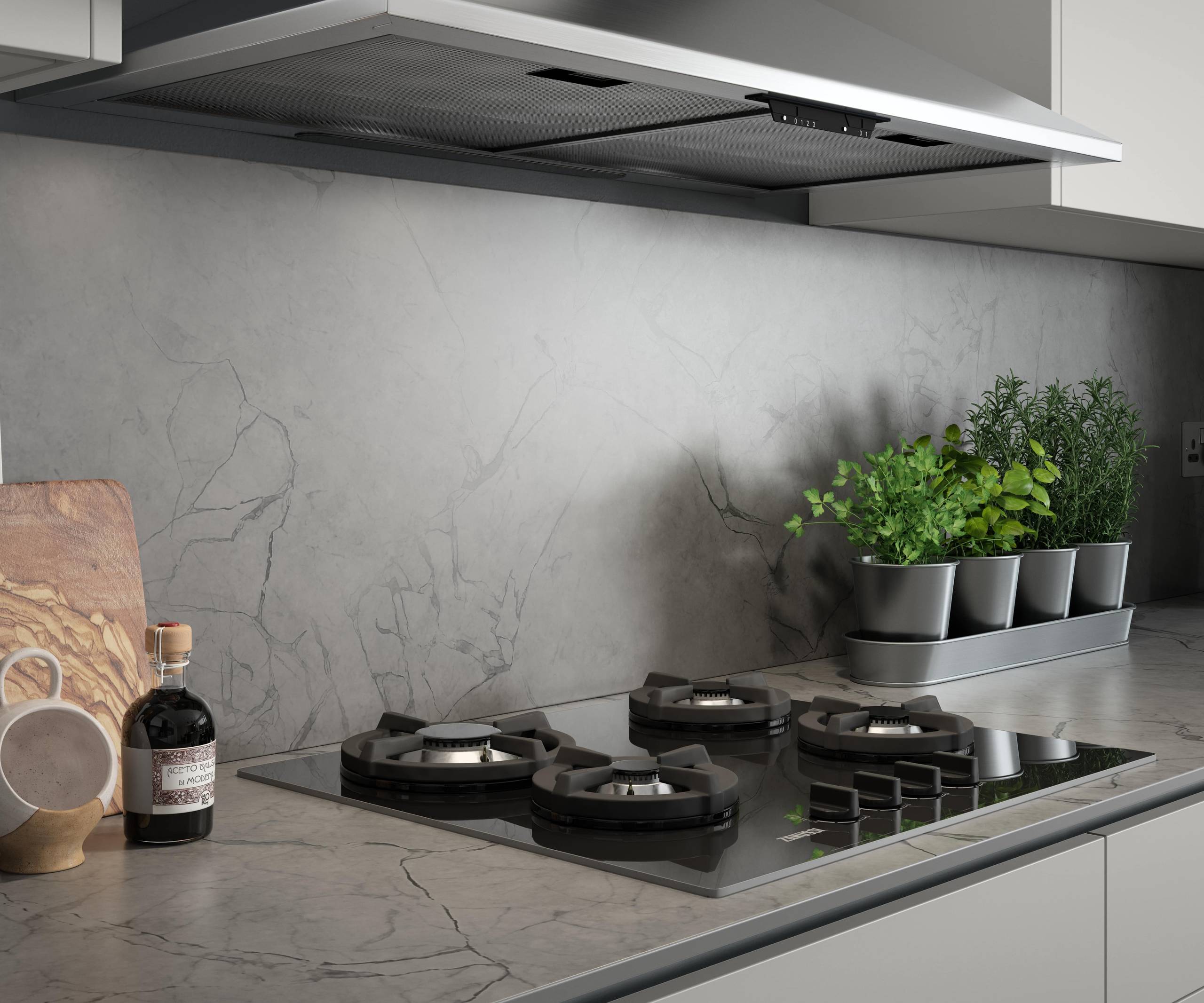 Close-up of hob on a grey and black marbled worktop and splashback in kitchen Integra Nova Grey by Magnet.