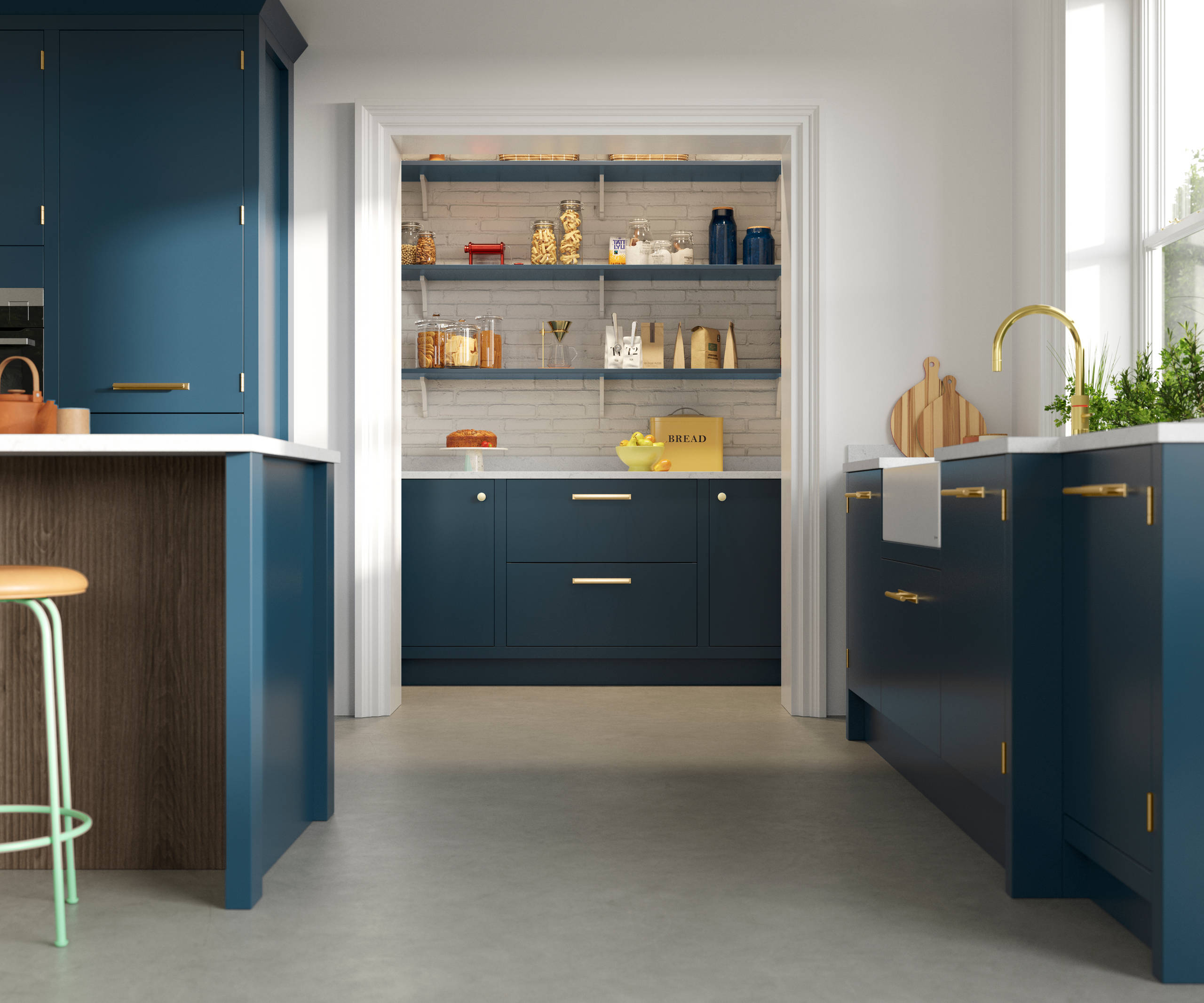 View of Soho Voyage Blue kitchen with brass accent details and pantry.
