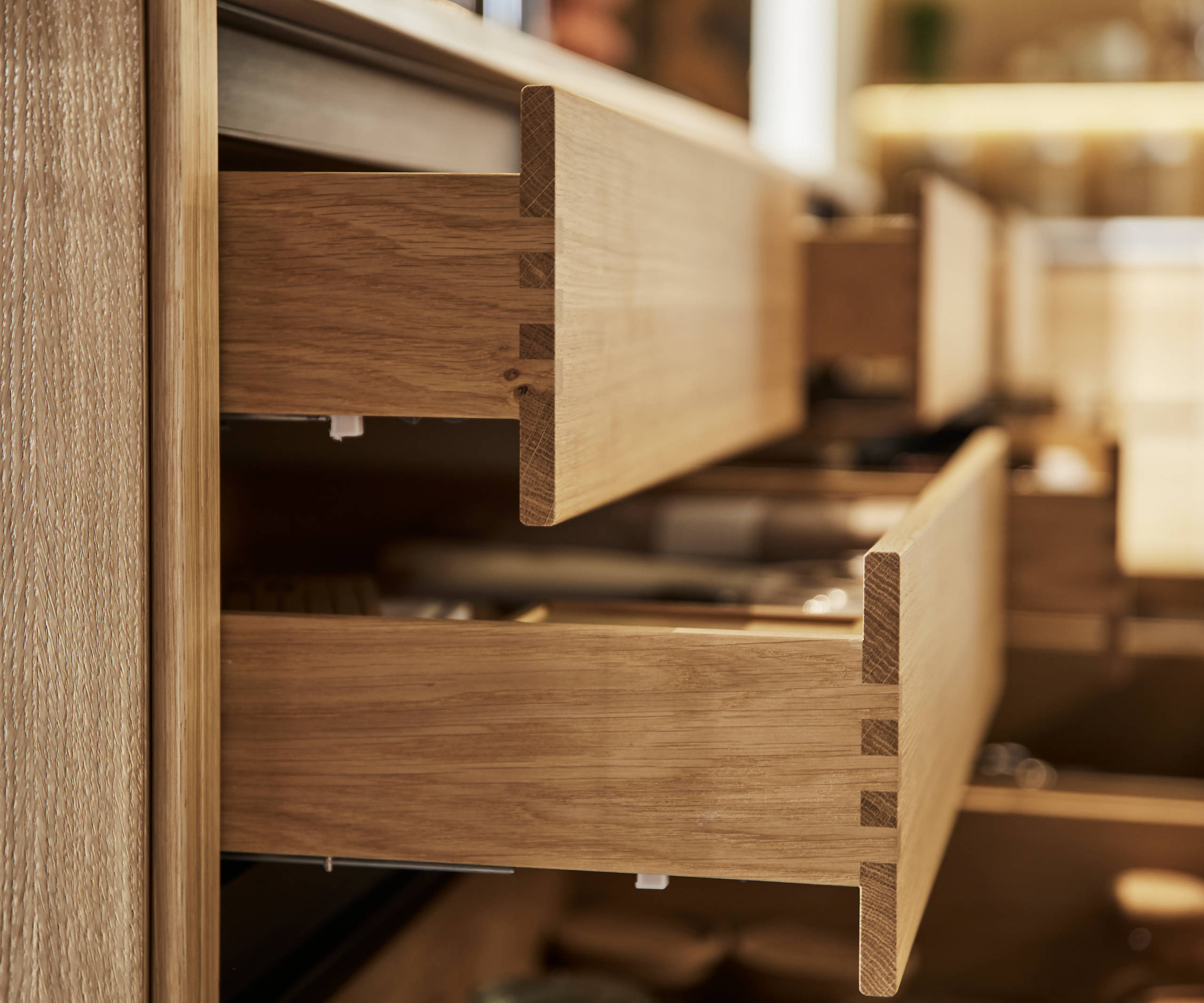 Close-up of opened oak drawers in Nordic Craft kitchen island.