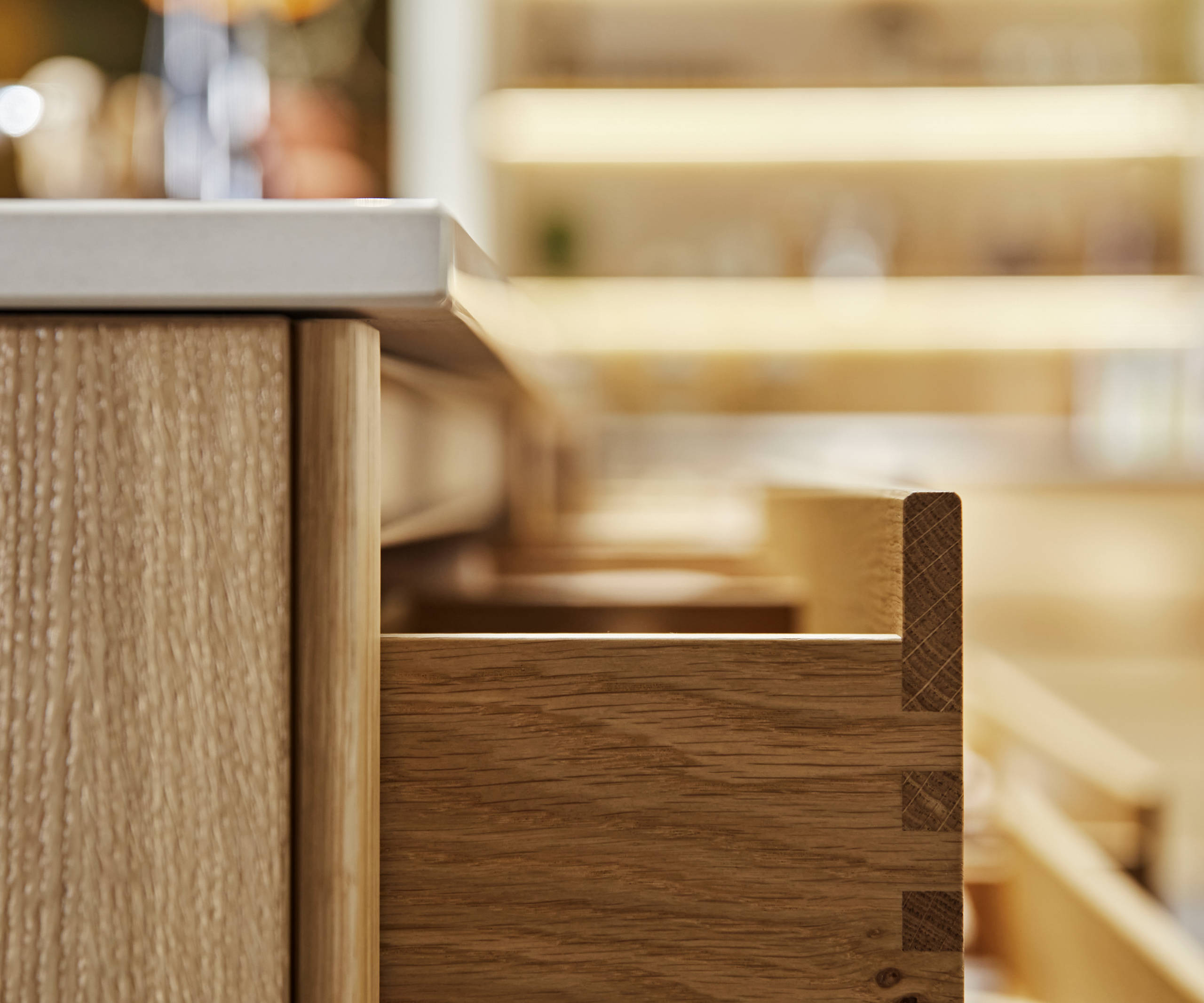 Close-up side view of opened oak drawer in Nordic Craft kitchen island.