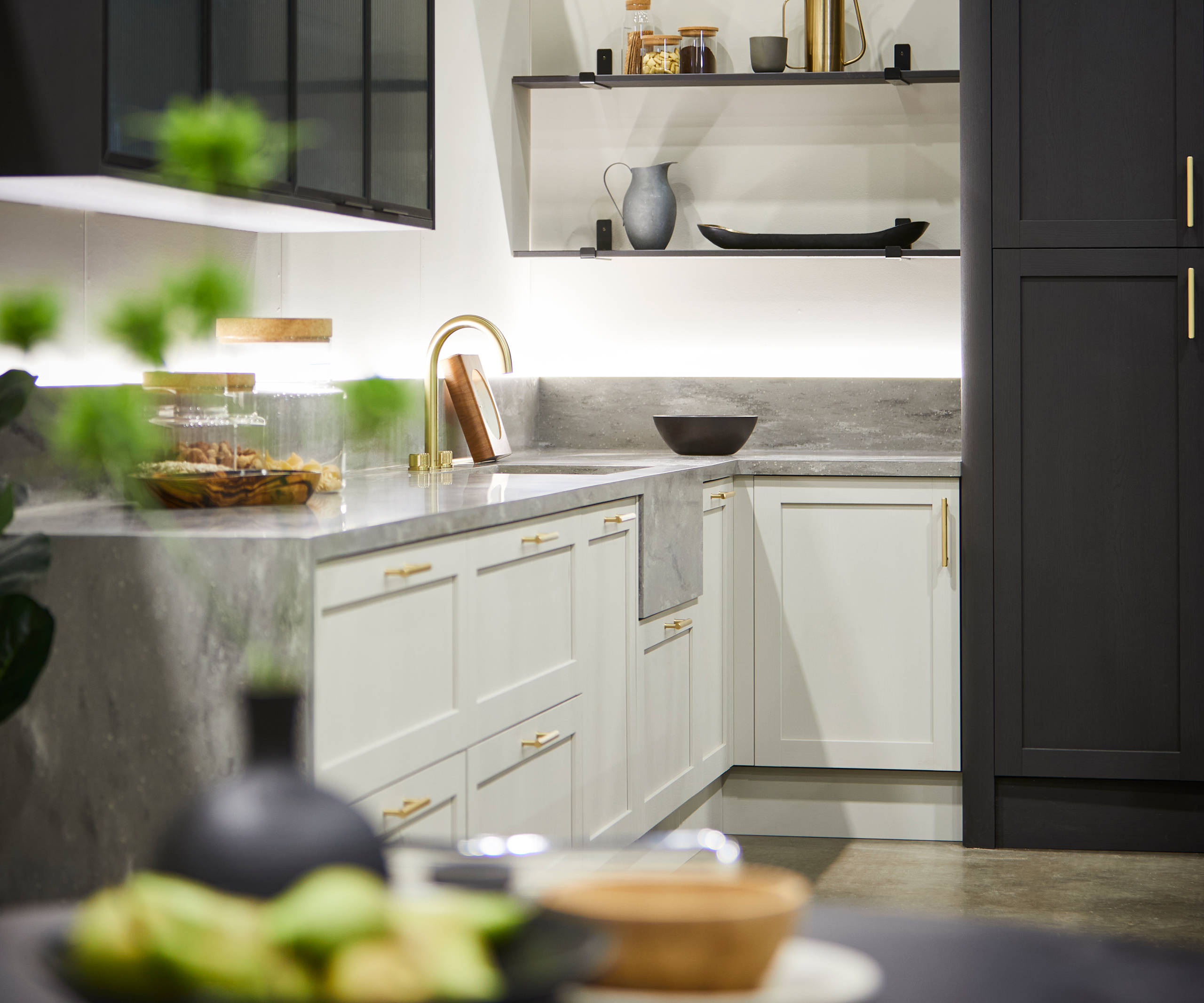 The Ambleside kitchen in Limestone and Graphite, showing full-height doors, drawer frontals and open shelving.