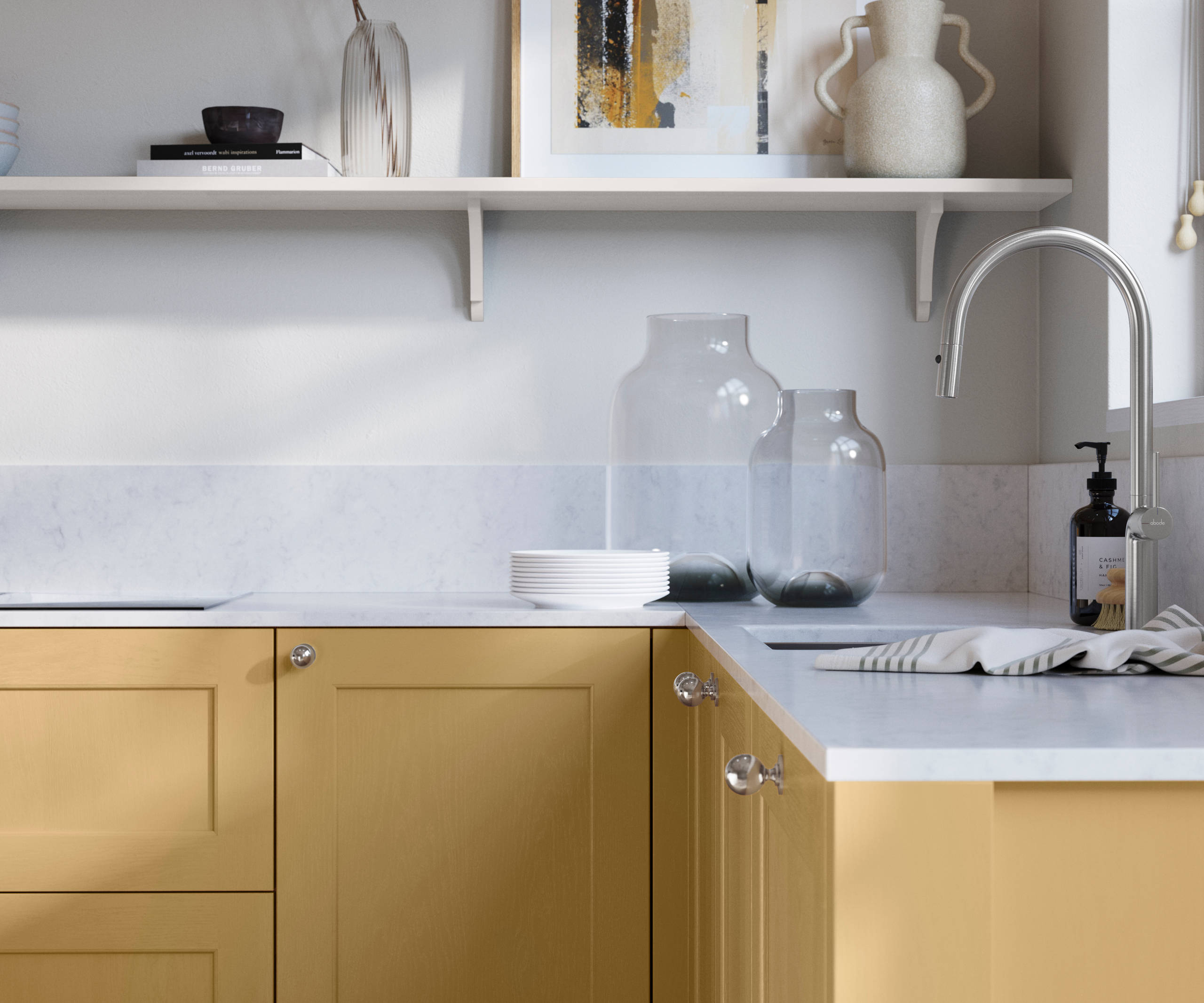 Ludlow, a traditional Shaker-style premium feel kitchen range with a visible woodgrain on its panelled doors here shown in the yellow shade Harvest styled with steel knobs, steel tap, a white marbled worktop with matching splashback.