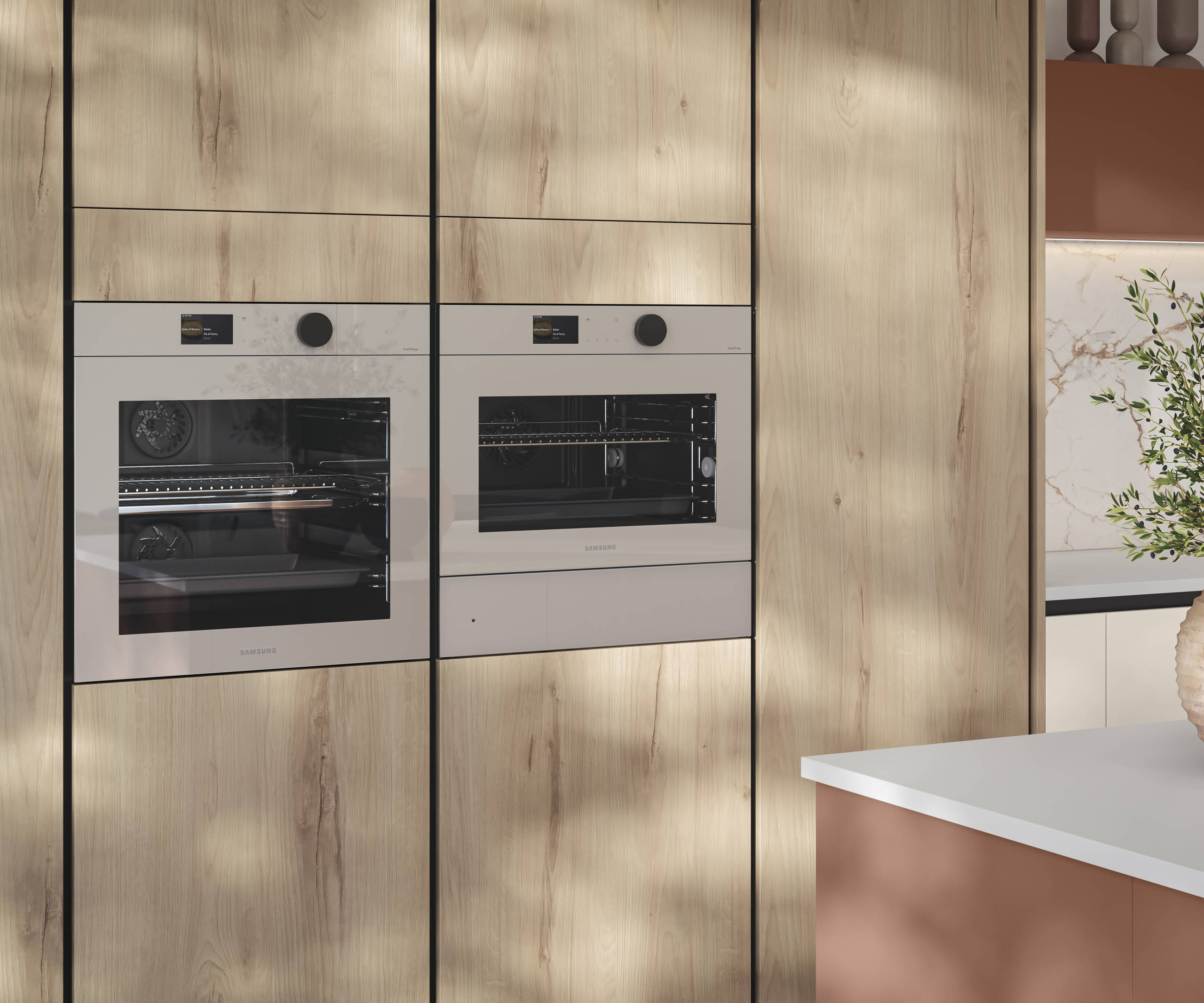 Tall Integra Portobello Bosco cabinetry, a contemporary handleless slab with with organic woodgrain texture, and integrated Samsung ovens.