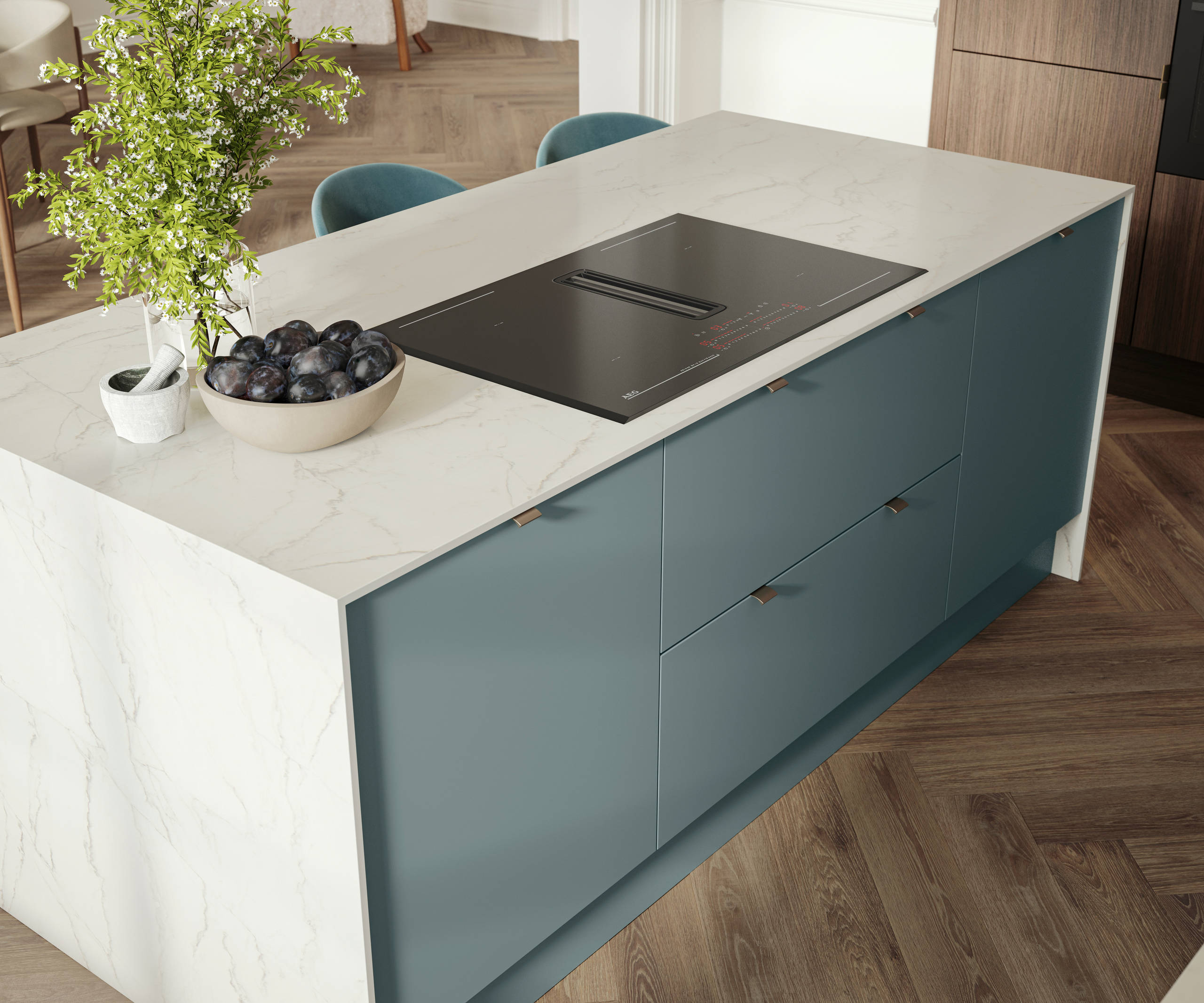 Overhead view of kitchen island with marbled dekton worktop, integrated hob and Soho Duck Blue cabinetry from Magnet.