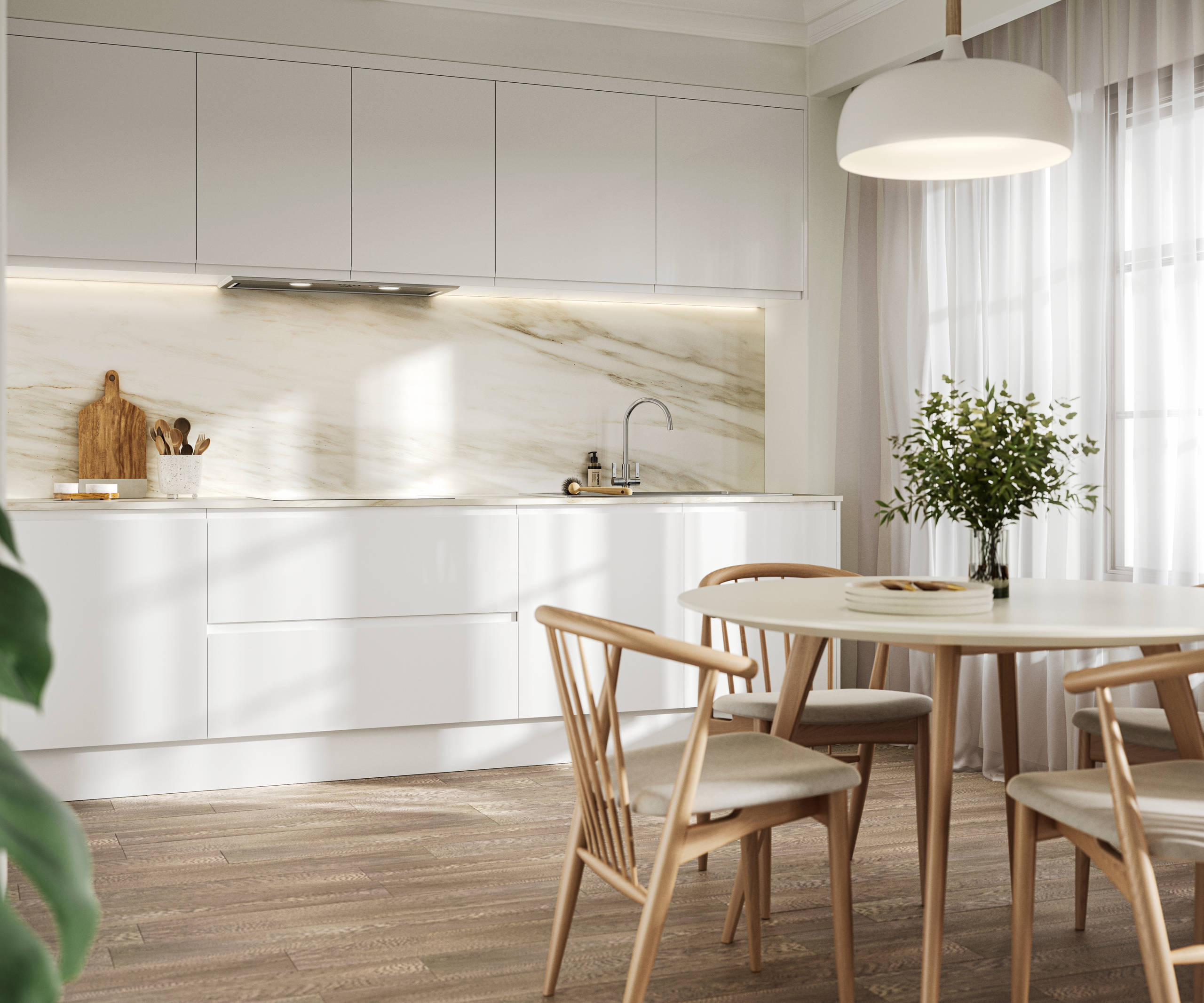 Handleless white gloss Luna kitchen from Magnet, a round wooden kitchen table with matching chairs in foreground
