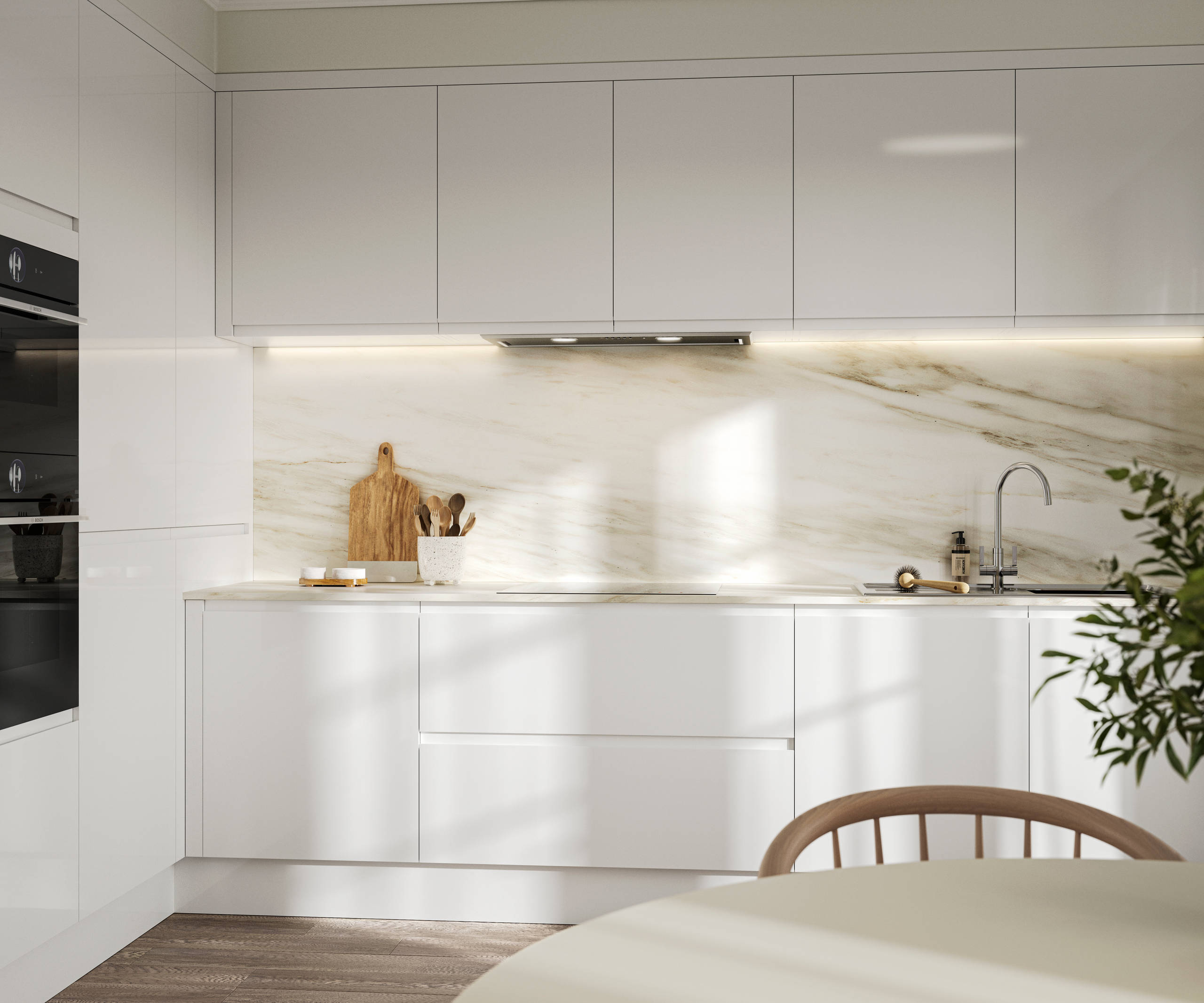 Handleless white gloss Luna kitchen from Magnet, with a white marbled worktop and backsplash.