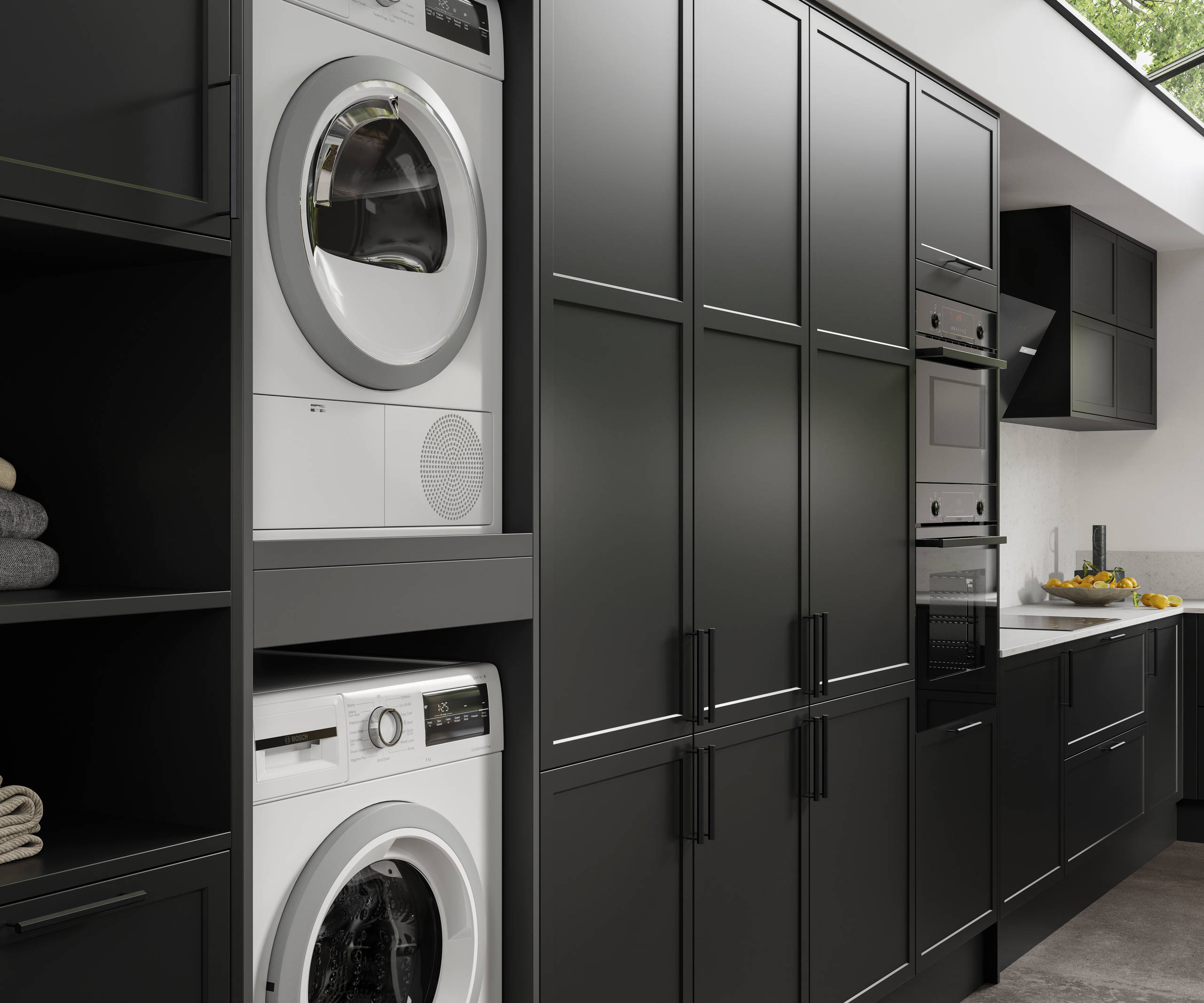 Integrated laundry machine and dryer, tall cabinets in black modern shaker Brunswick kitchen and laundry room.