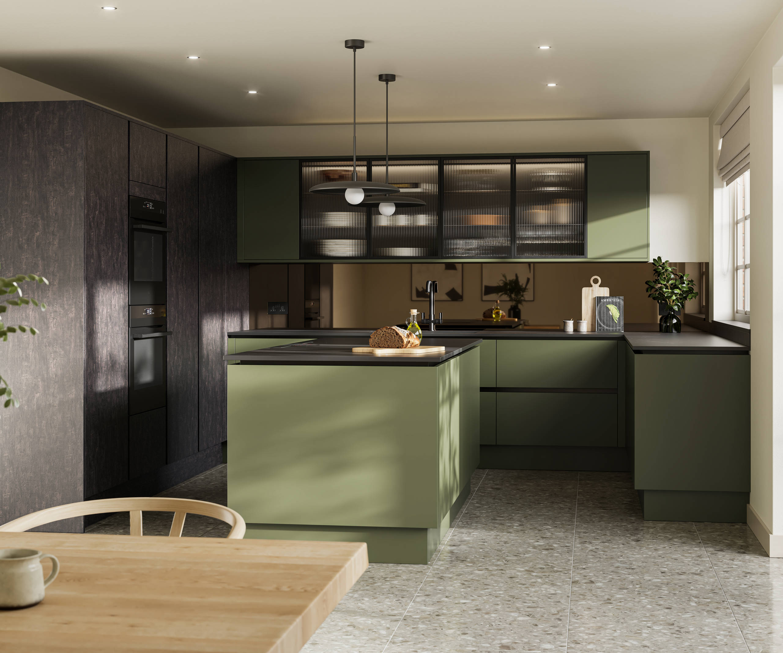 Integra Soho Tailored Green kitchen and kitchen island with contrasting dark wood Portobello Etna, black accessories, integrated ovens in tall cabinets, Dekton worktop and fluted glass vitrin wall cabinets with wood dining room table in foreground.