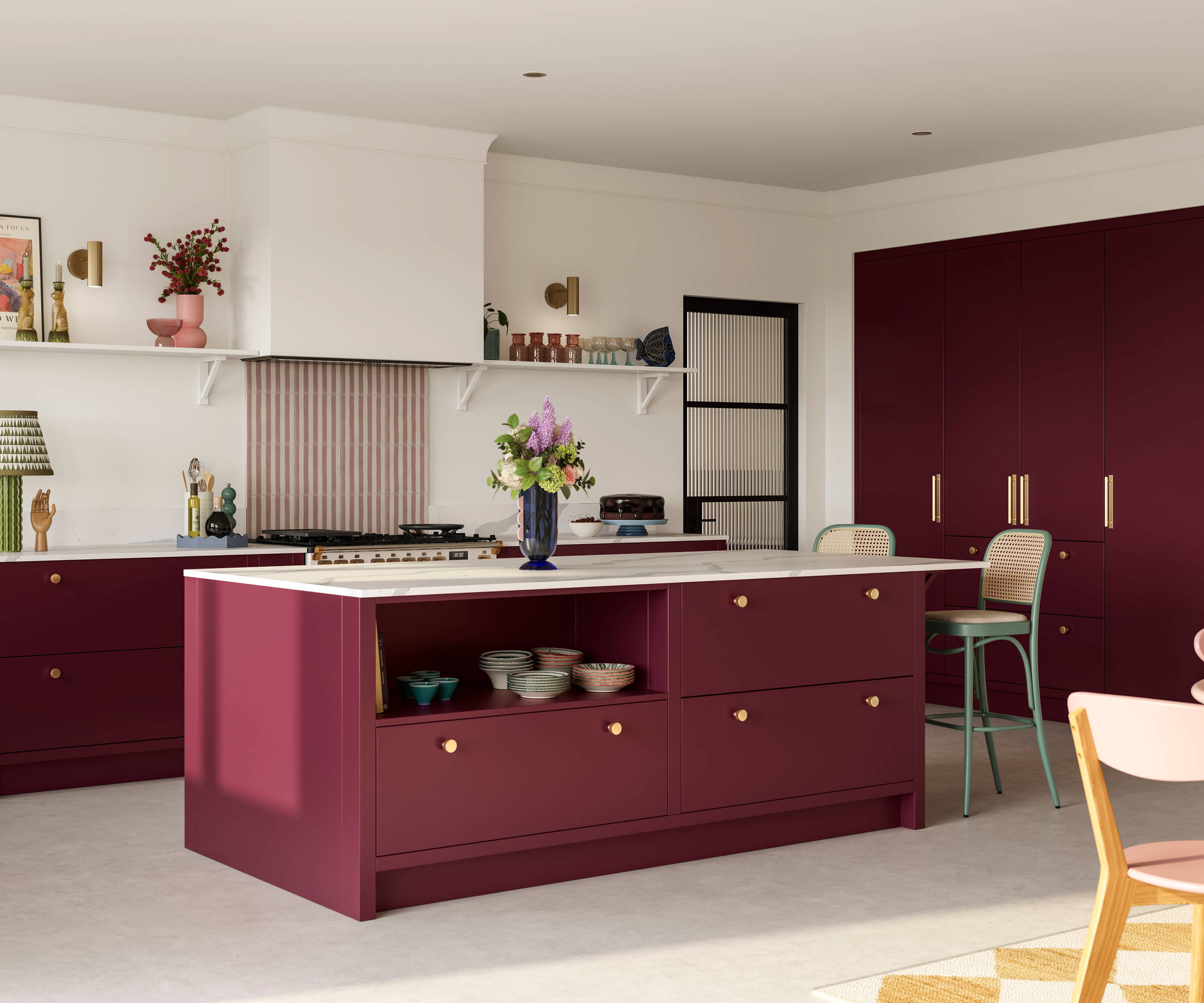 Modern slab front Soho Morello kitchen with built-in tall cabinets hiding integrated refrigerator, kitchen island with rattan bar stools at breakfast bar, Bianco calacatta worktop and upstand, brass knobs and open shelf in kitchen island holding eclectic eramics.