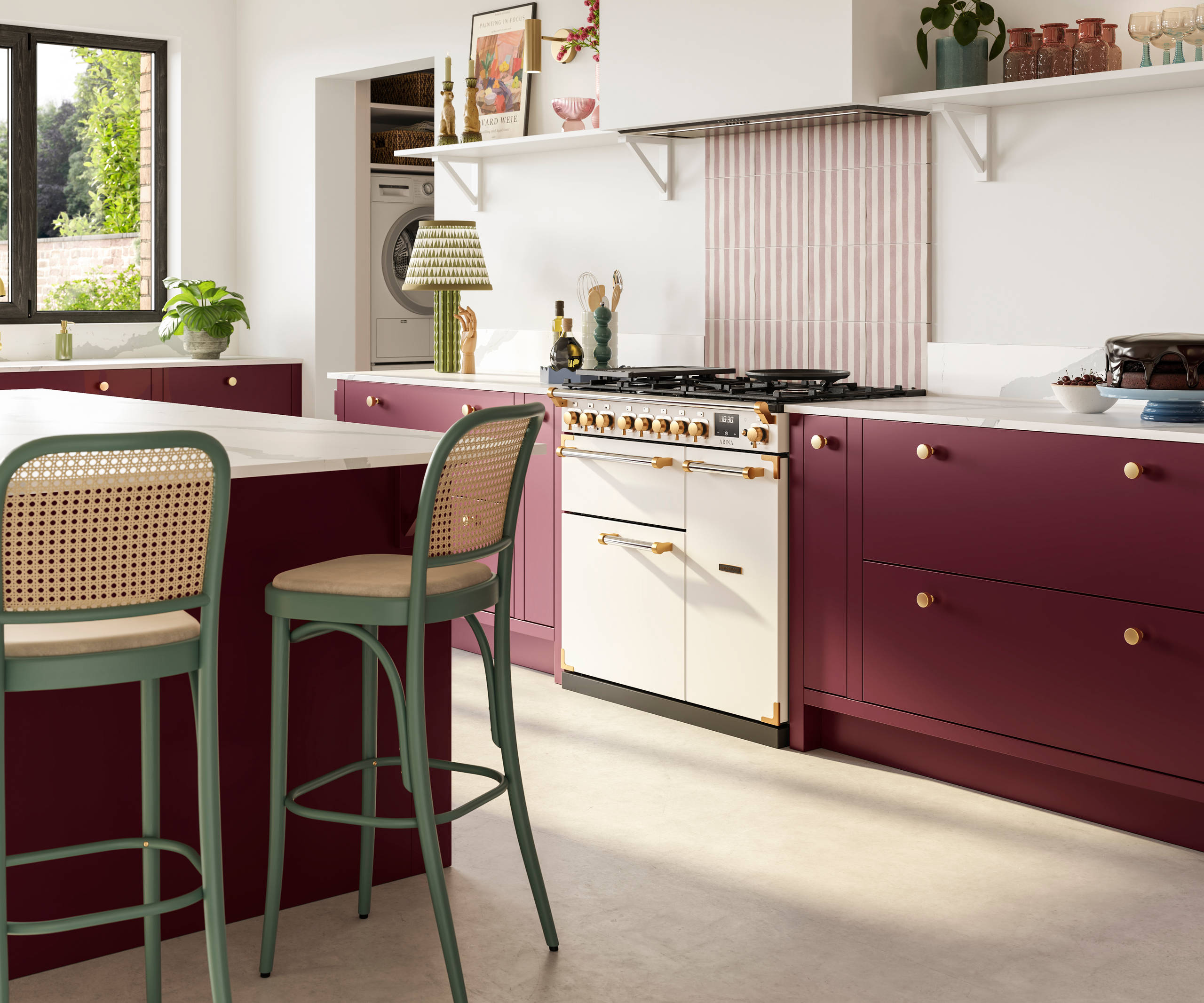 Modern slab front Soho Morello kitchen. kitchen island with rattan bar stools at breakfast bar, Bianco calacatta worktop and upstand, brass knobs and Otto tiles dirty pink stripes as splashback behind range cooker.