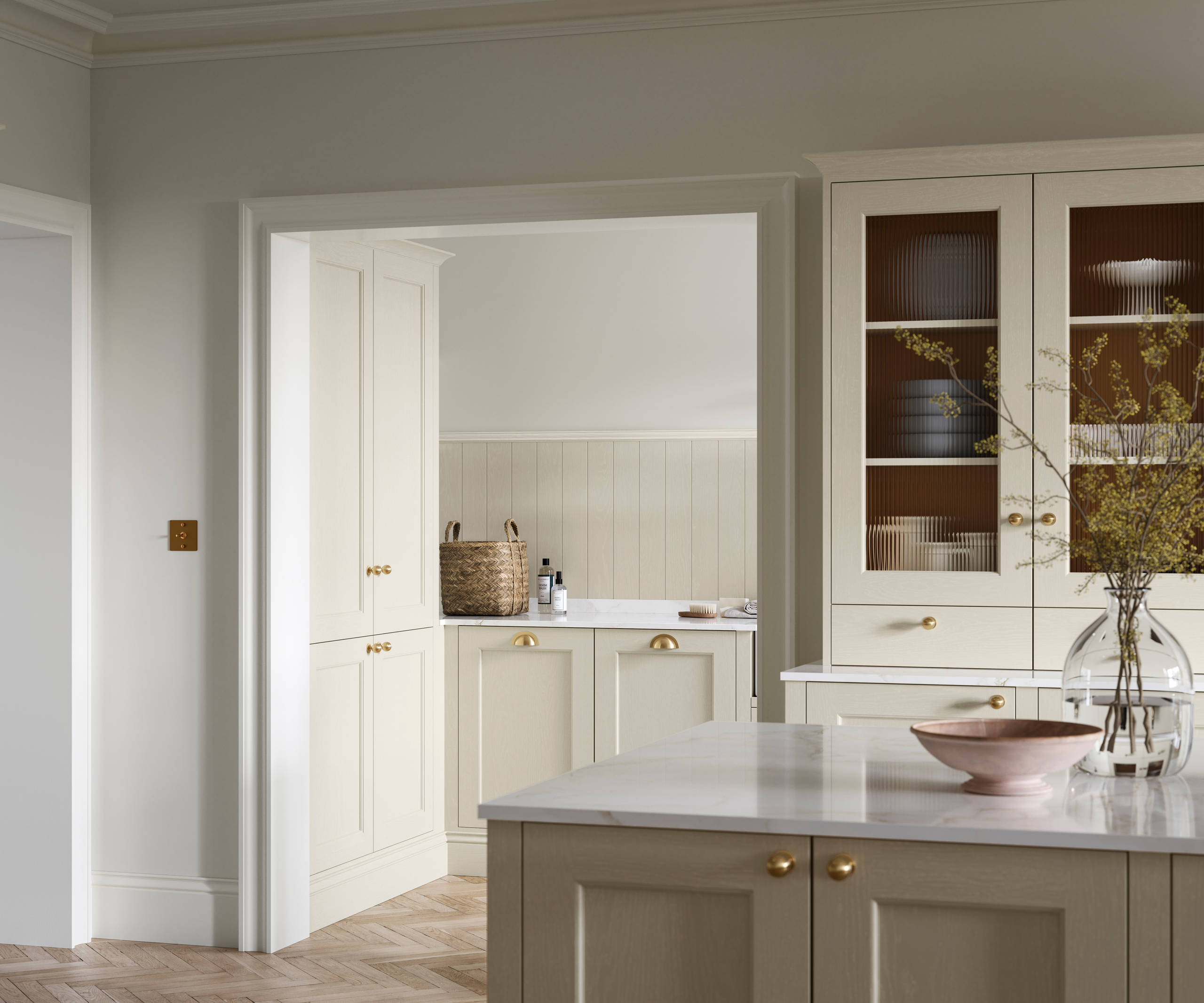 Open plan living room and Traditional Shaker-style kitchen Ludlow Parchment and view of utility room with white ceramic trough door frame, Goodrich Natural Oak herringbone engineered flooring, brass handles, brass knobs and bras tap.