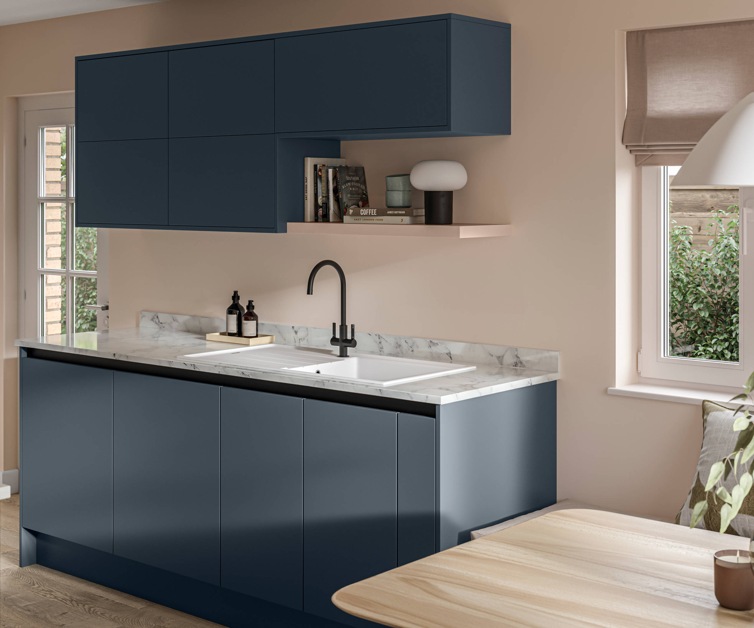 Handleless Integra Ascoli Mineral Blue, a dark blue kitchen with a wood wall shelf, rounded matt black tap with white sink, a white and grey marbled worktop with matching upstand.