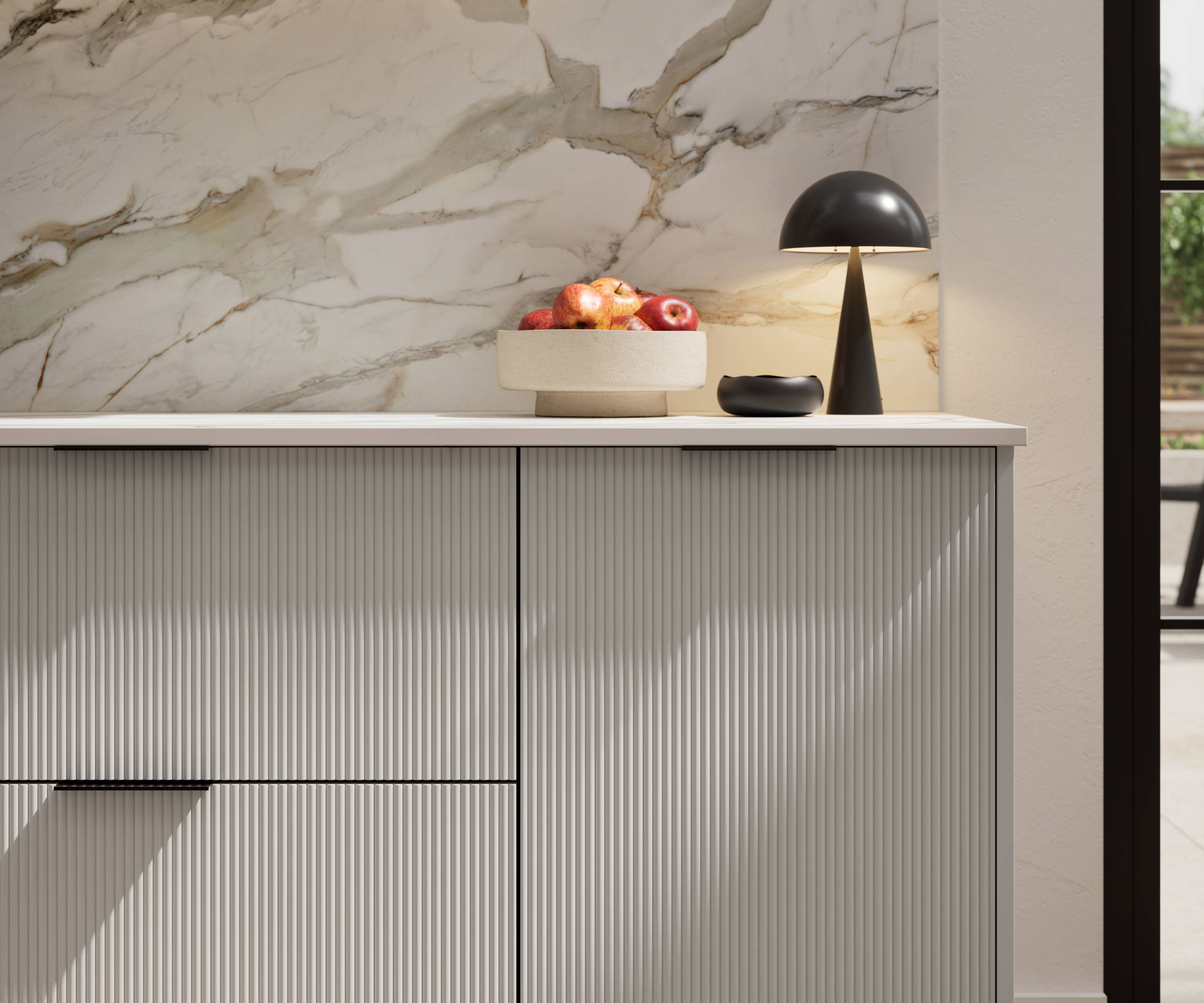 Fluted front kitchen Reed from Magnet in soft grey shade Dove Grey, with a marbled splashback and black handles, herringbone wood flooring.