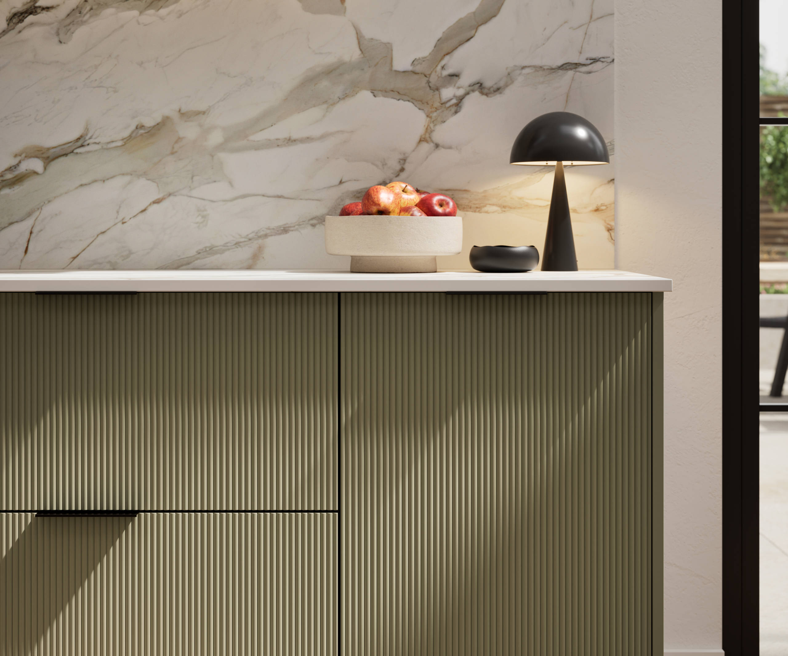 Fluted front kitchen Reed from Magnet in deep green shade Balmoral, with a marbled splashback and black handles, herringbone wood flooring.