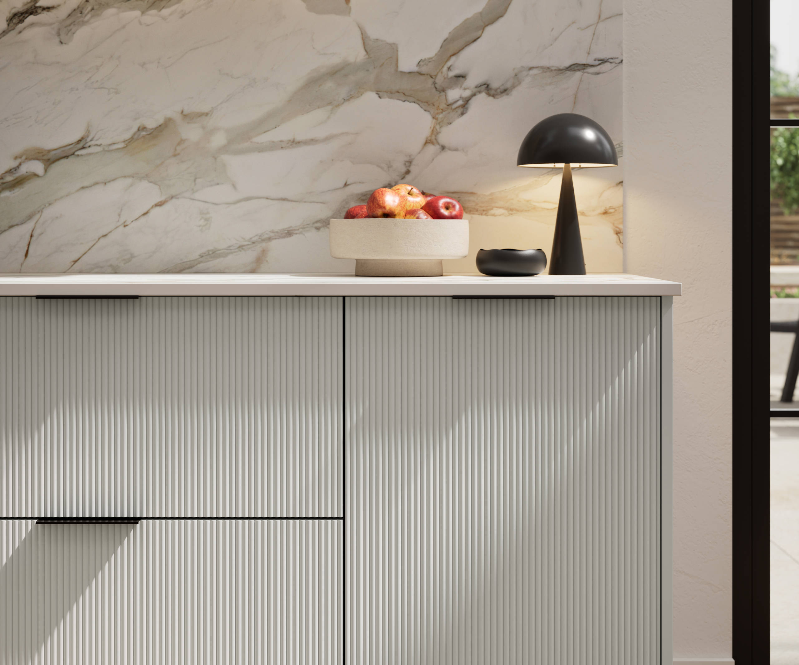 Fluted front kitchen Reed from Magnet in light neutral shade Washed cotton, with a marbled splashback and black handles, herringbone wood flooring.