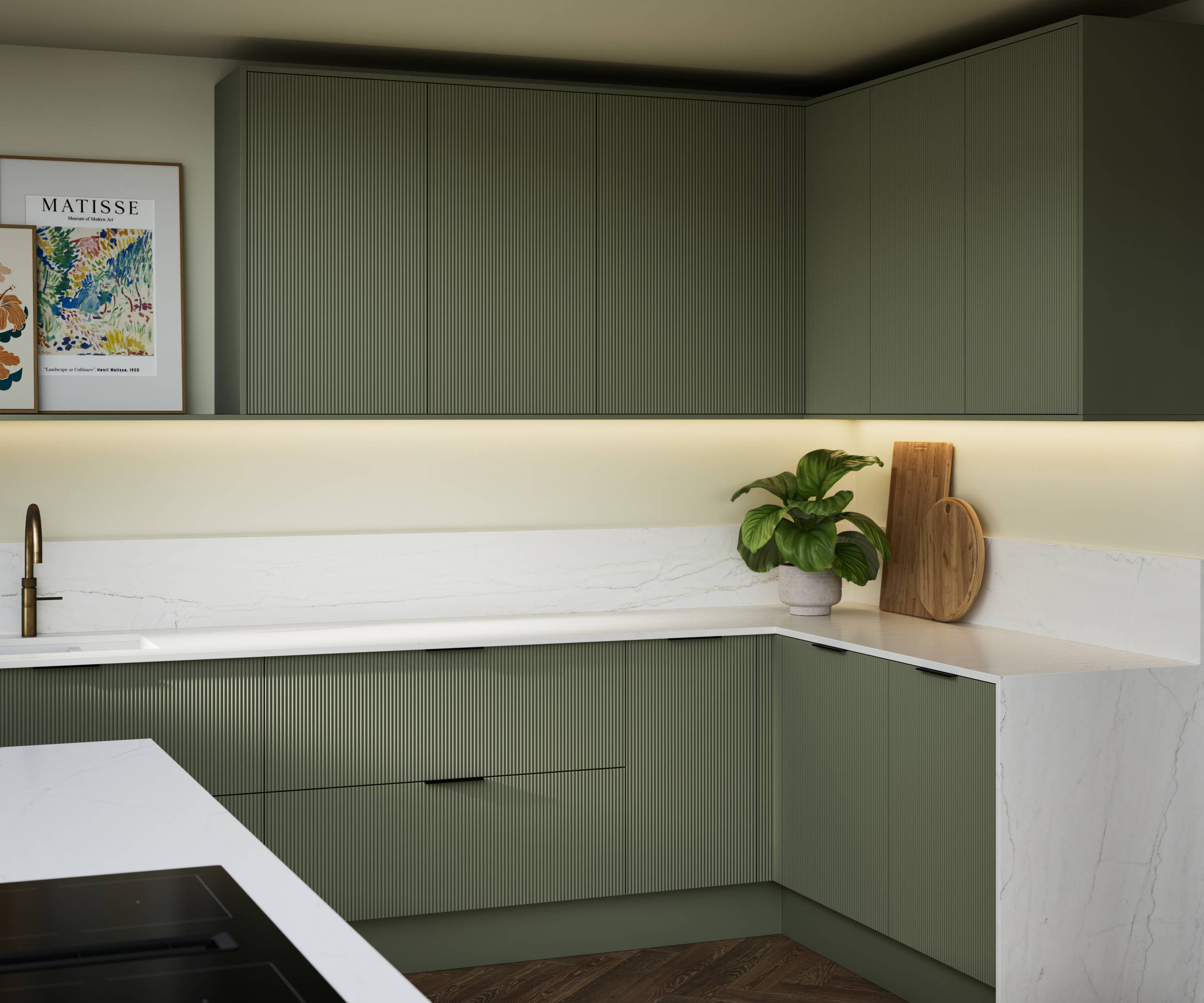 Green fluted kitchen fronts on kitchen cabinets with black handles, white marble worktop, upstand and matching decorative sides.