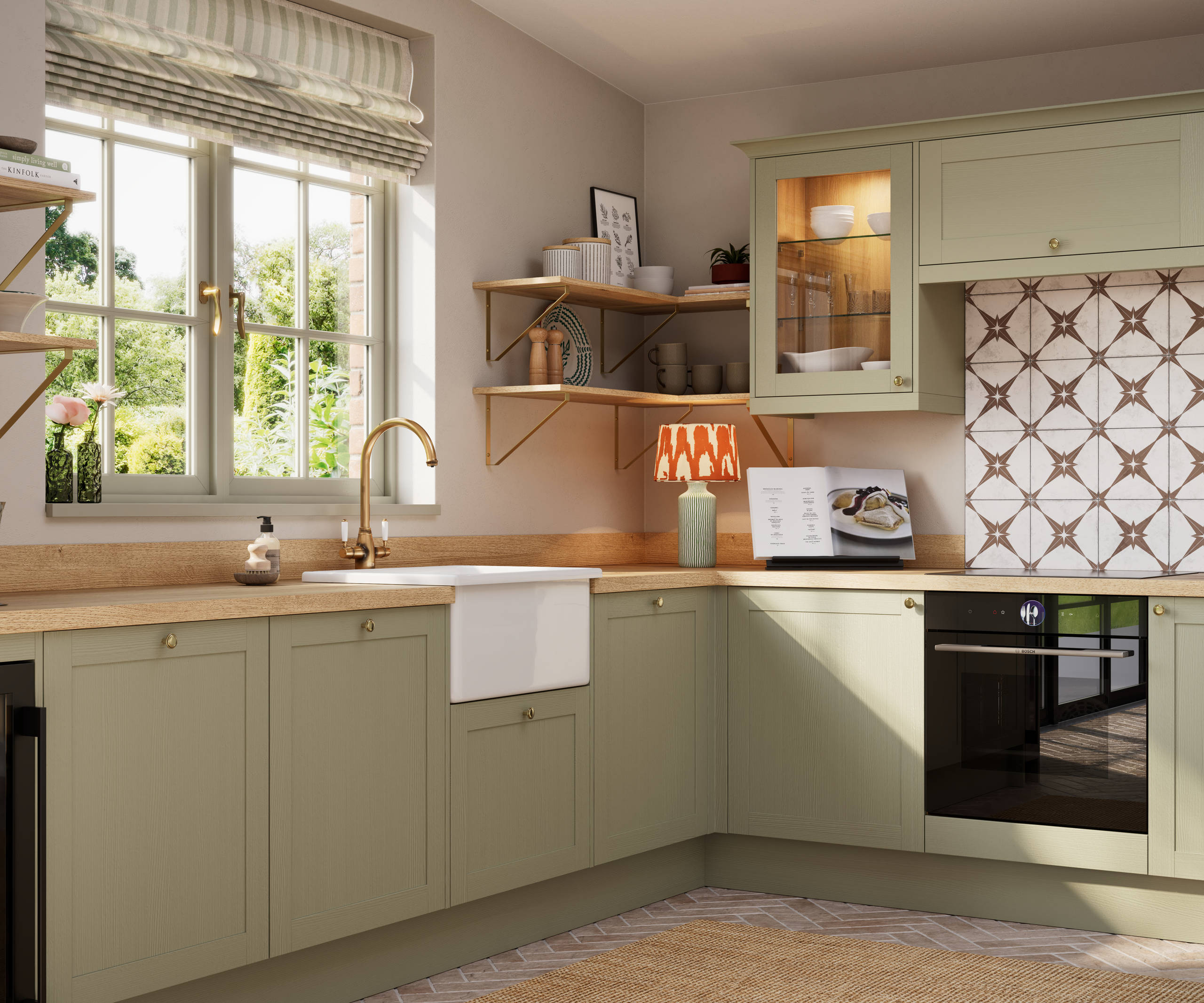 Close-up view of contemporary Shaker kitchen Ambleside from Magnet in sage green shade Meadow with belfast sink, aged taps and wooden effect worktop.