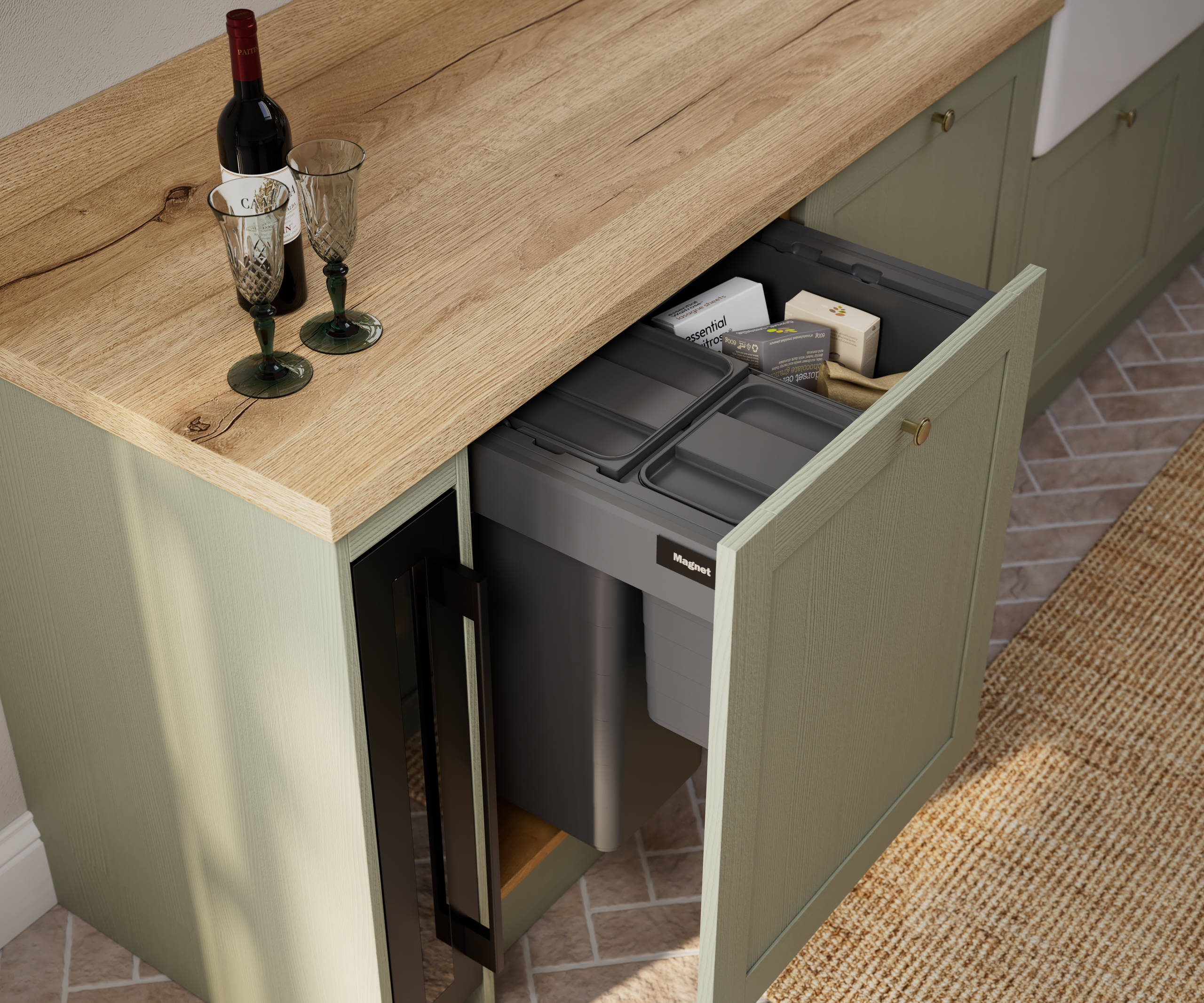 Contemporary Shaker kitchen Ambleside from Magnet in sage green shade Meadow with integrated recycling bins and wooden effect worktop.
